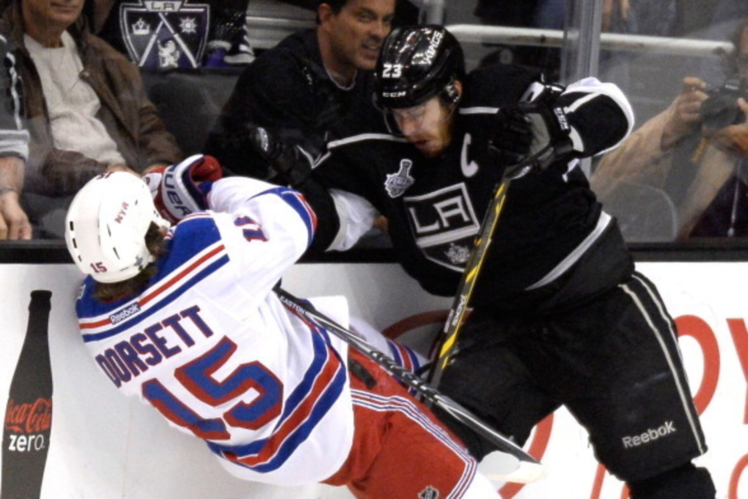 LOS ANGELES, CA - JUNE 13:  Dustin Brown #23 of the Los Angeles Kings checks Derek Dorsett #15 of the New York Rangers in the first period during Game Five of the 2014 Stanley Cup Final at Staples Center on June 13, 2014 in Los Angeles, California.  (Phot