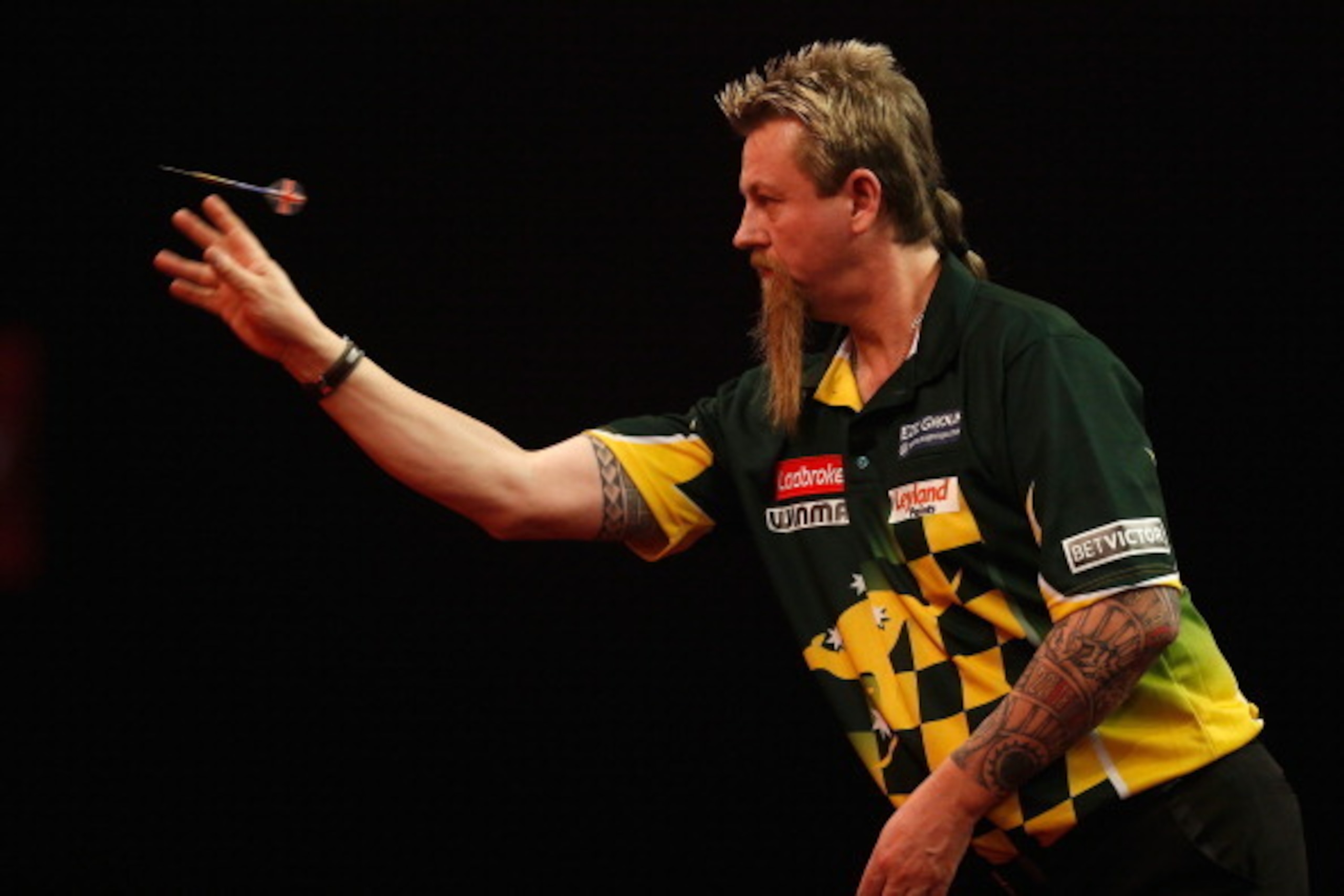 LONDON, ENGLAND - DECEMBER 28:  Simon Whitlock of Australia in action during his quarter final match against Ian White of England on day thirteen of the Ladbrokes.com World Darts Championship at Alexandra Palace on December 28, 2013 in London, England.  (