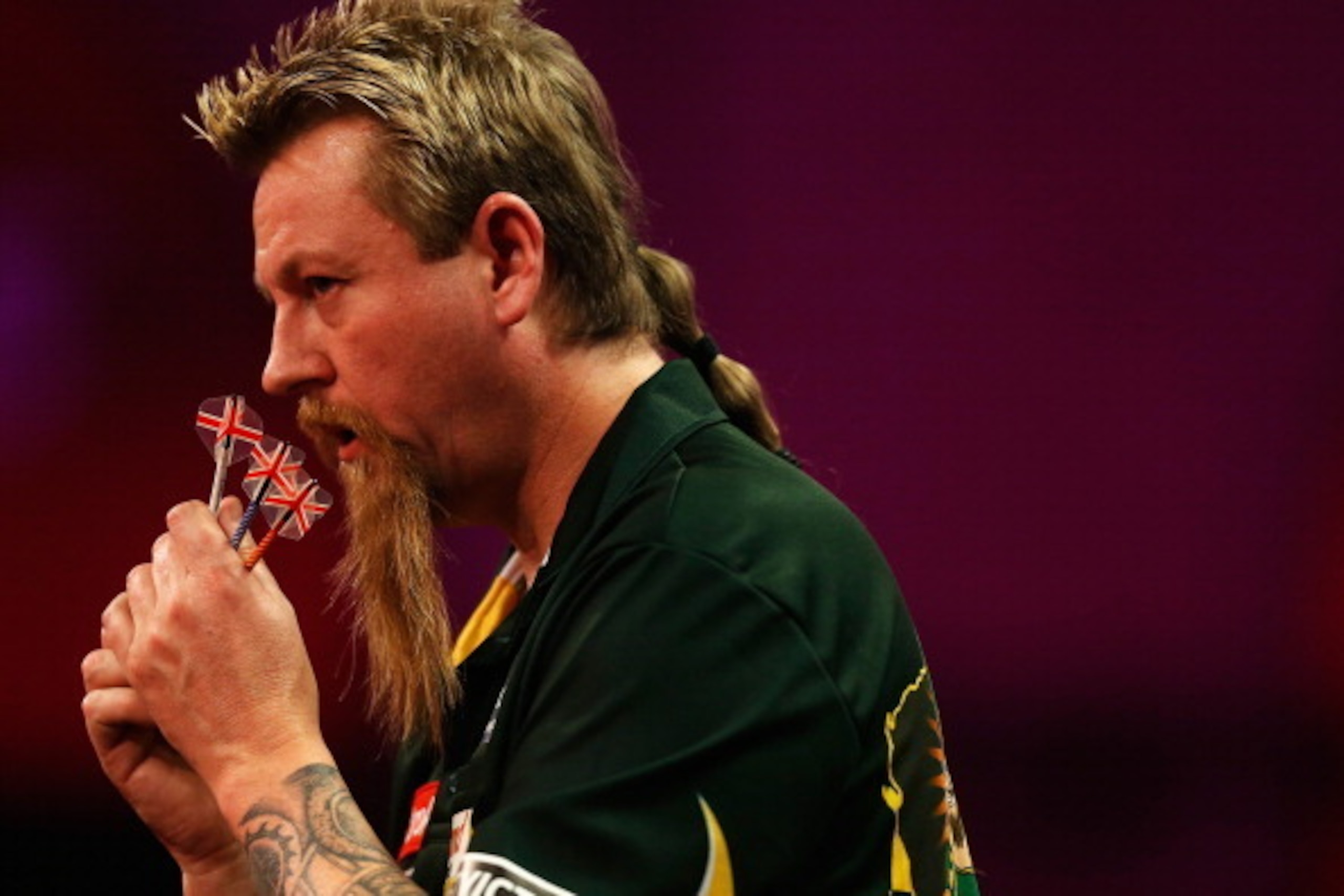 LONDON, ENGLAND - DECEMBER 28:  Simon Whitlock of Australia in action during his quarter final match against Ian White of England on day thirteen of the Ladbrokes.com World Darts Championship at Alexandra Palace on December 28, 2013 in London, England.  (