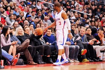 LOS ANGELES, CA - FEBRUARY 13: Chris Paul #3 of the Los Angeles Clippers tosses a basketball to team owner Donald Sterling during a game against the Houston Rockets at Staples Center on February 13, 2013 in Los Angeles, California. NOTE TO USER: User expr