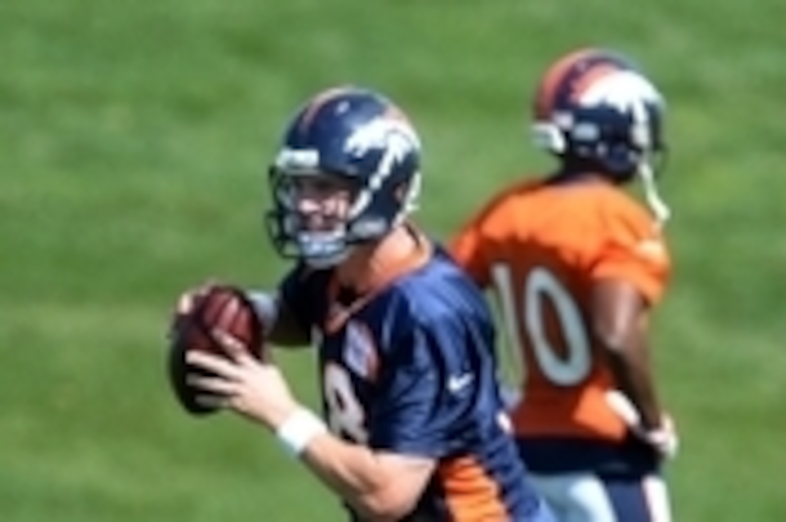 Jul 24, 2014; Dove Valley, CO, USA; Denver Broncos quarterback Peyton Manning (18) prepares to pass during training camp activities at the Broncos training facility. Mandatory Credit: Ron Chenoy-USA TODAY Sports