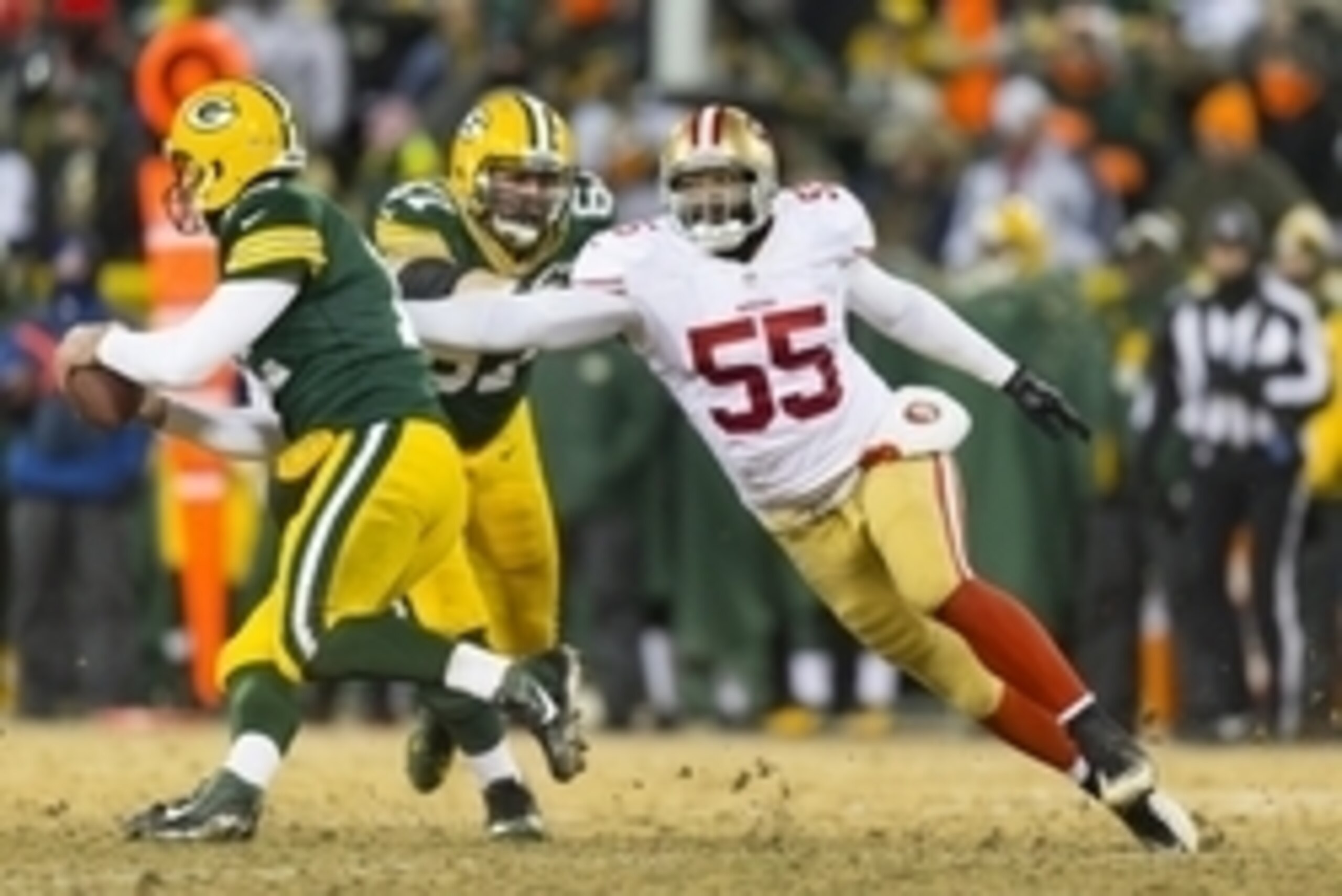 Jan 5, 2014; Green Bay, WI, USA; San Francisco 49ers linebacker Ahmad Brooks (55) chases Green Bay Packers quarterback Aaron Rodgers (12) during the third quarter of the 2013 NFC wild card playoff football game at Lambeau Field. Mandatory Credit: Jeff Han