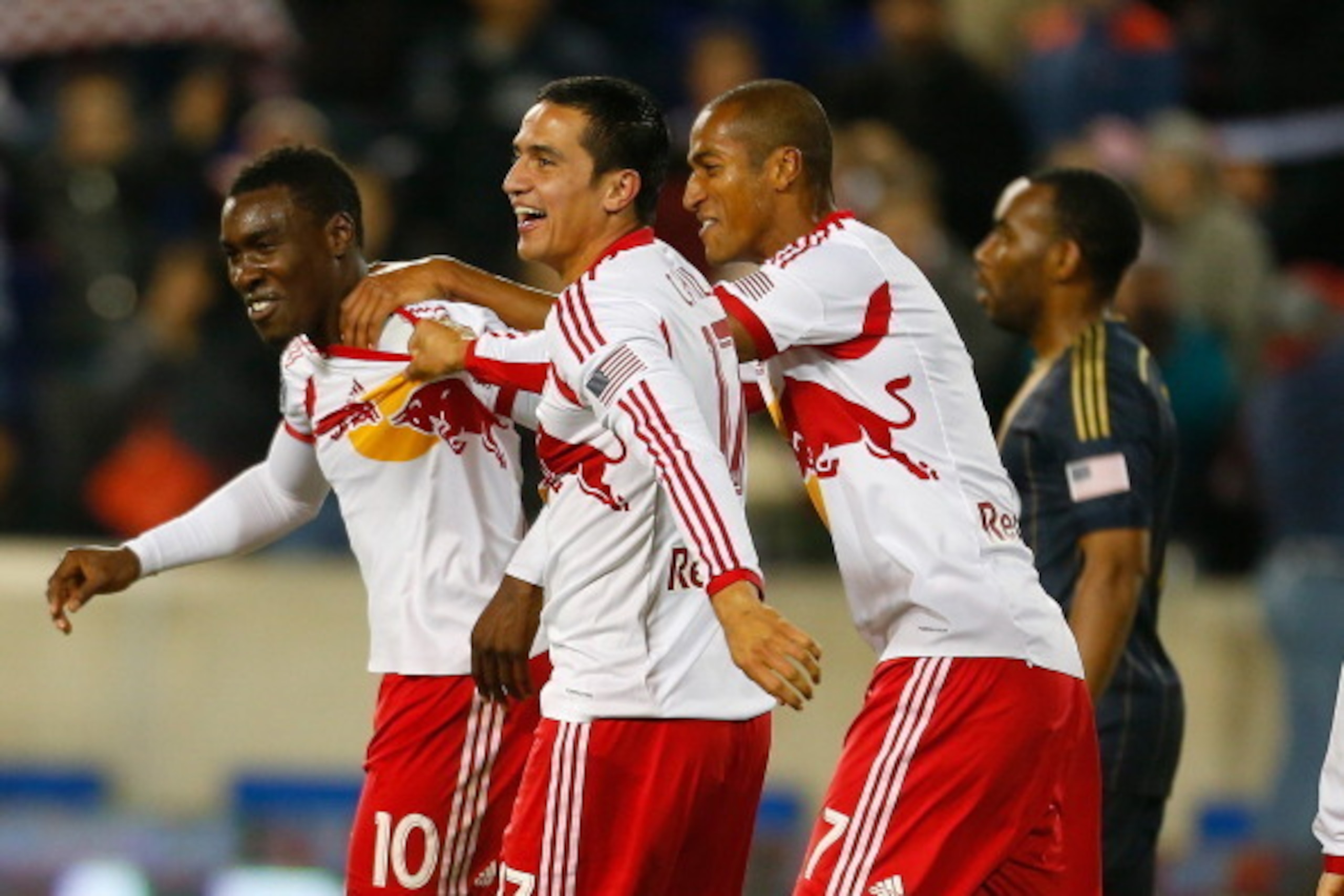HARRISON, NJ - APRIL 16:  Lloyd Sam #10 of the New York Red Bulls is mobbed by teammates Tim Cahill #17 and Roy Miller #7 after scoring in the 67th minute against the Philadelphia Union at Red Bull Arena on April 16, 2014 in Harrison, New Jersey. Red Bull
