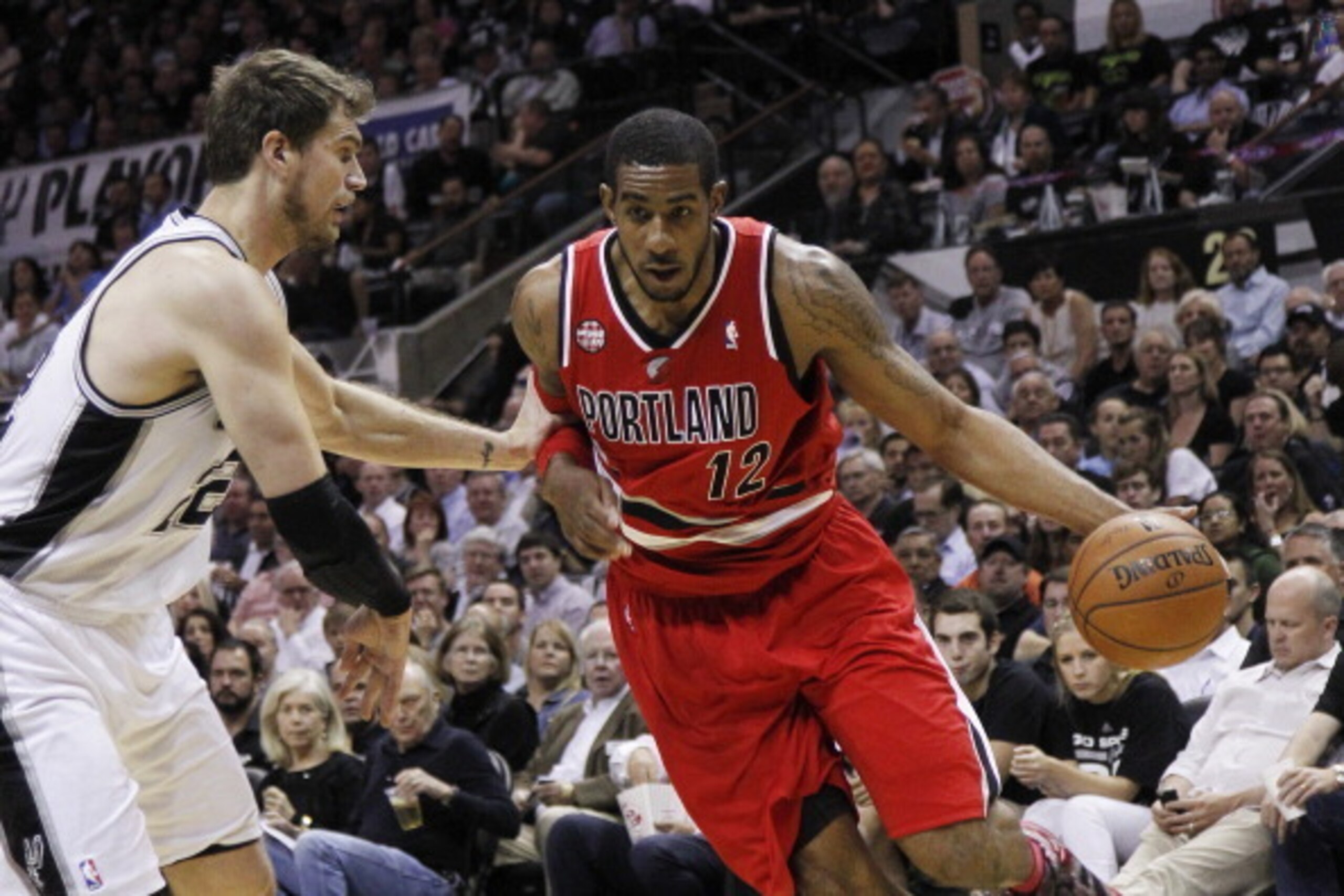 SAN ANTONIO, TX - MAY 14:  LaMarcus Aldridge #12 of the Portland Trail Blazers drives around Tiago Splitter #22 of the San Antonio Spurs in Game Five of the Western Conference Semifinals during the 2014 NBA Playoffs at the AT&T Center on May 14, 2014 in S