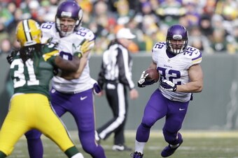 GREEN BAY, WI - NOVEMBER 24:  Davon House #31 of the Green Bay Packers is blocked as Toby Gerhart #32 of the Minnesota Vikings runs the ball at Lambeau Field on November 24, 2013 in Green Bay, Wisconsin.  (Photo Tom Lynn /Getty Images)