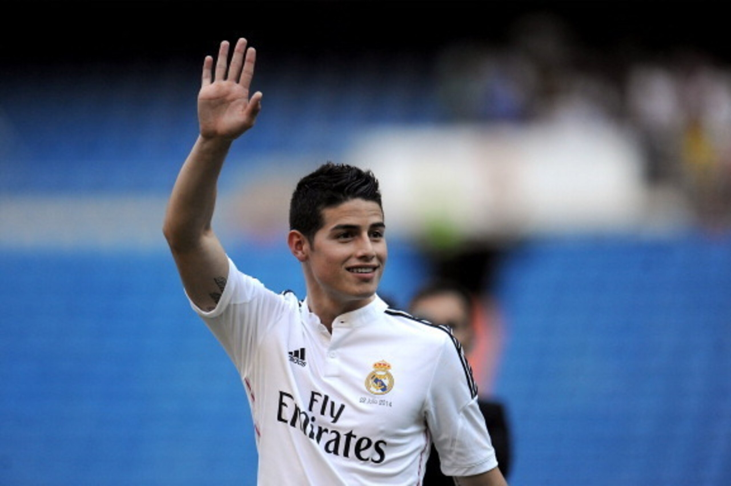MADRID, SPAIN - JULY 22:  James Rodriguez waves to fans during his unveiling as a new Real Madrid player at the Santaigo Bernabeu stadium on July 22, 2014 in Madrid, Spain. Real agreed to buy Rodriguez from AS Monaco for the next six seasons for an undisc