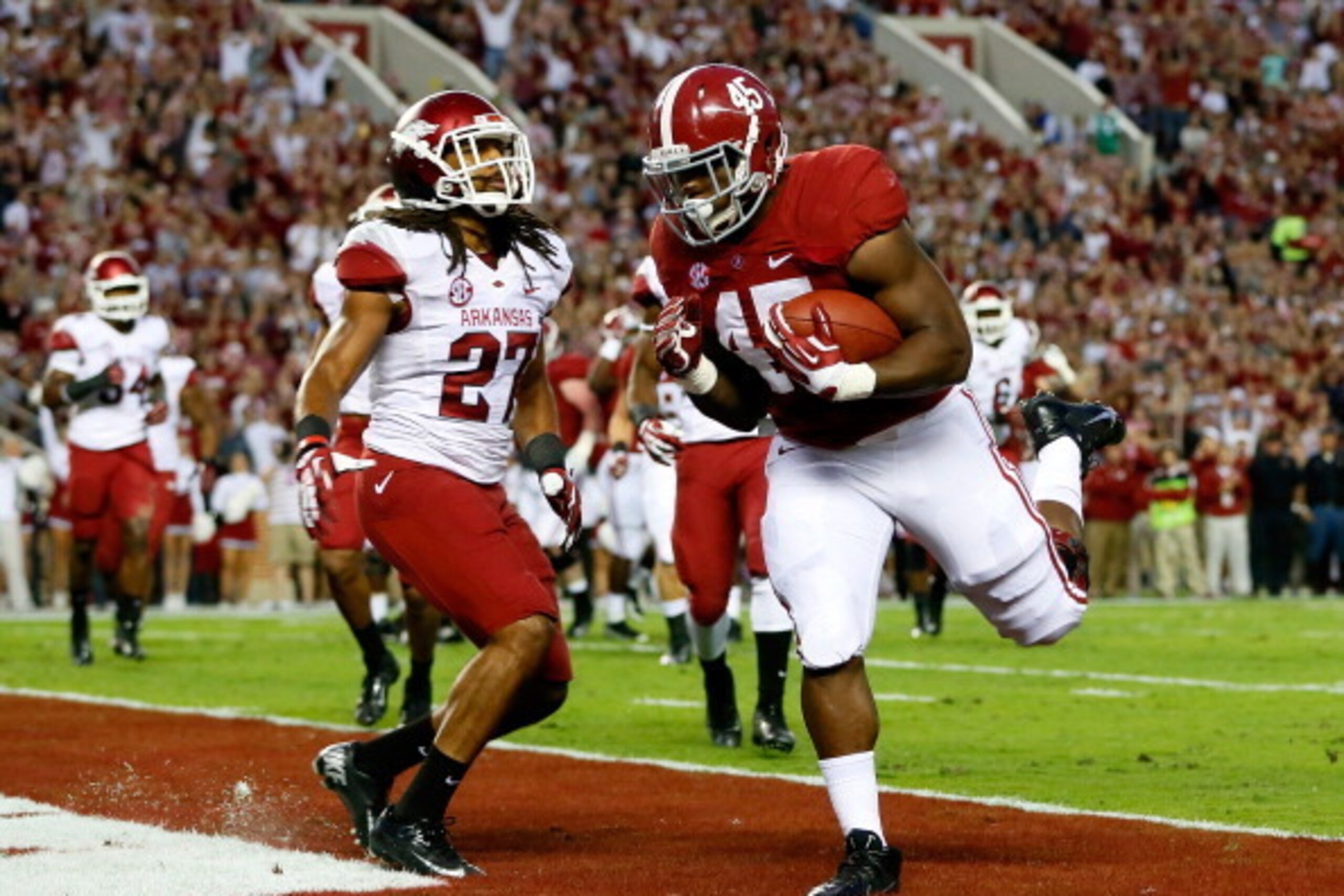 TUSCALOOSA, AL - OCTOBER 19:  Jalston Fowler #45 of the Alabama Crimson Tide scores a touchdown past Alan Turner #27 of the Arkansas Razorbacks at Bryant-Denny Stadium on October 19, 2013 in Tuscaloosa, Alabama.  (Photo by Kevin C. Cox/Getty Images)