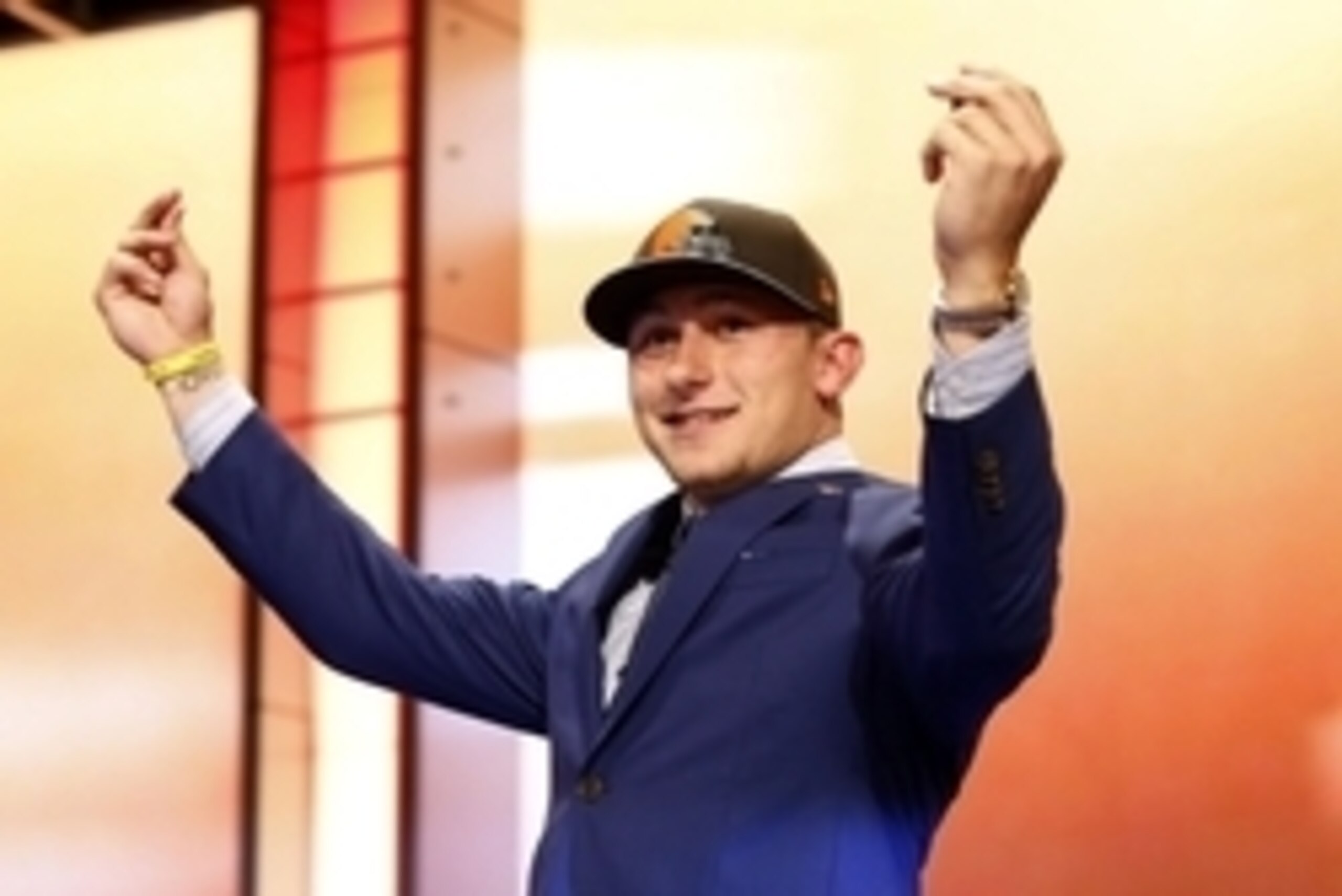 May 8, 2014; New York, NY, USA; Johnny Manziel (Texas A&M) gestures as he walks across the stage after being selected as the number twenty-two overall pick in the first round of the 2014 NFL Draft to the Cleveland Browns at Radio City Music Hall. Mandator
