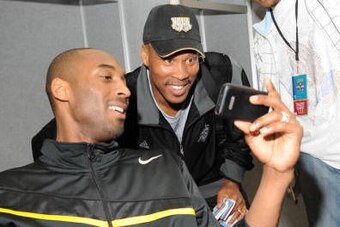 NEW ORLEANS - FEBRUARY 16: Kobe Bryant and Byron Scott of the West All-Stars look at Kobe Bryant's iPhone prior to the West All-Stars Practice on center court at NBA Jam Session presented by Addidas at the Earnest N. Morial Convention Center February 16, 