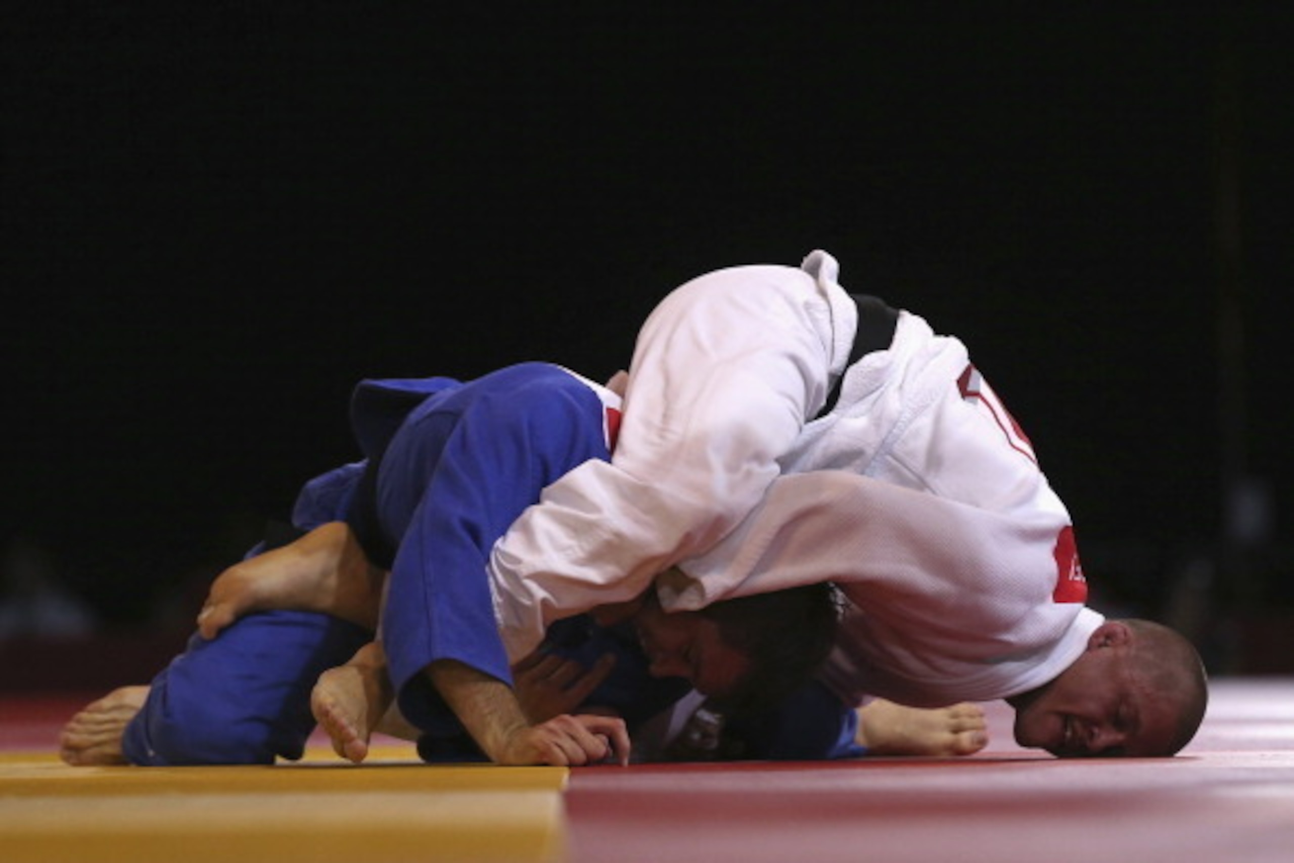 GLASGOW, SCOTLAND - JULY 25:  Owen Livesey of England (white) competes with Tom Reed of England (blue) in the Men's -81kg judo final at SECC Precinct during day two of the Glasgow 2014 Commonwealth Games on July 25, 2014 in Glasgow, United Kingdom.  (Phot