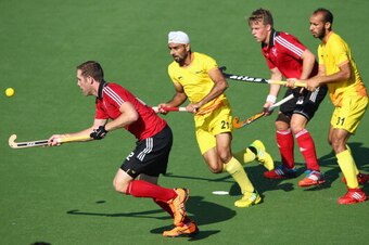 GLASGOW, SCOTLAND - JULY 25:  Gurwinder Chandi of India tries to trackle Richard Gay of Wales during the Mens Hockey match between India and Wales at Glasgow National Hockey Centre during day two of the Glasgow 2014 Commonwealth Games on July 25, 2014 in 