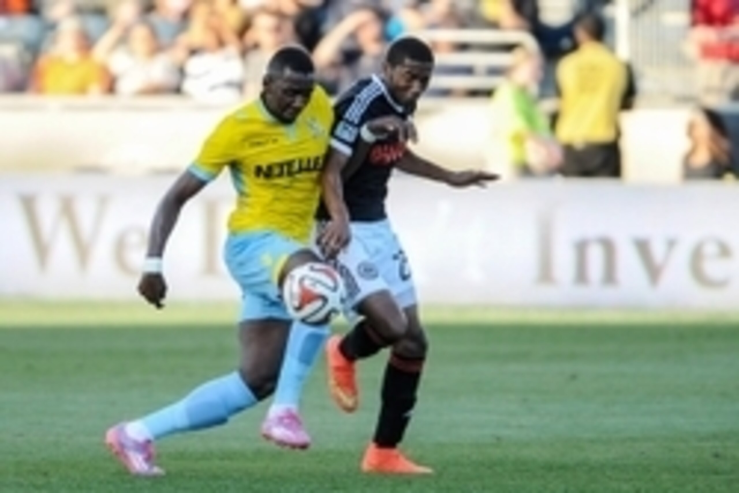 Jul 25, 2014; Chester, PA, USA; Crystal Palace midfielder Yannick Bolasie (7) battles with Philadelphia Union defender Raymon Gaddis (28) for control of the ball during the first half of the match at PPL Park. Mandatory Credit: John Geliebter-USA TODAY Sp