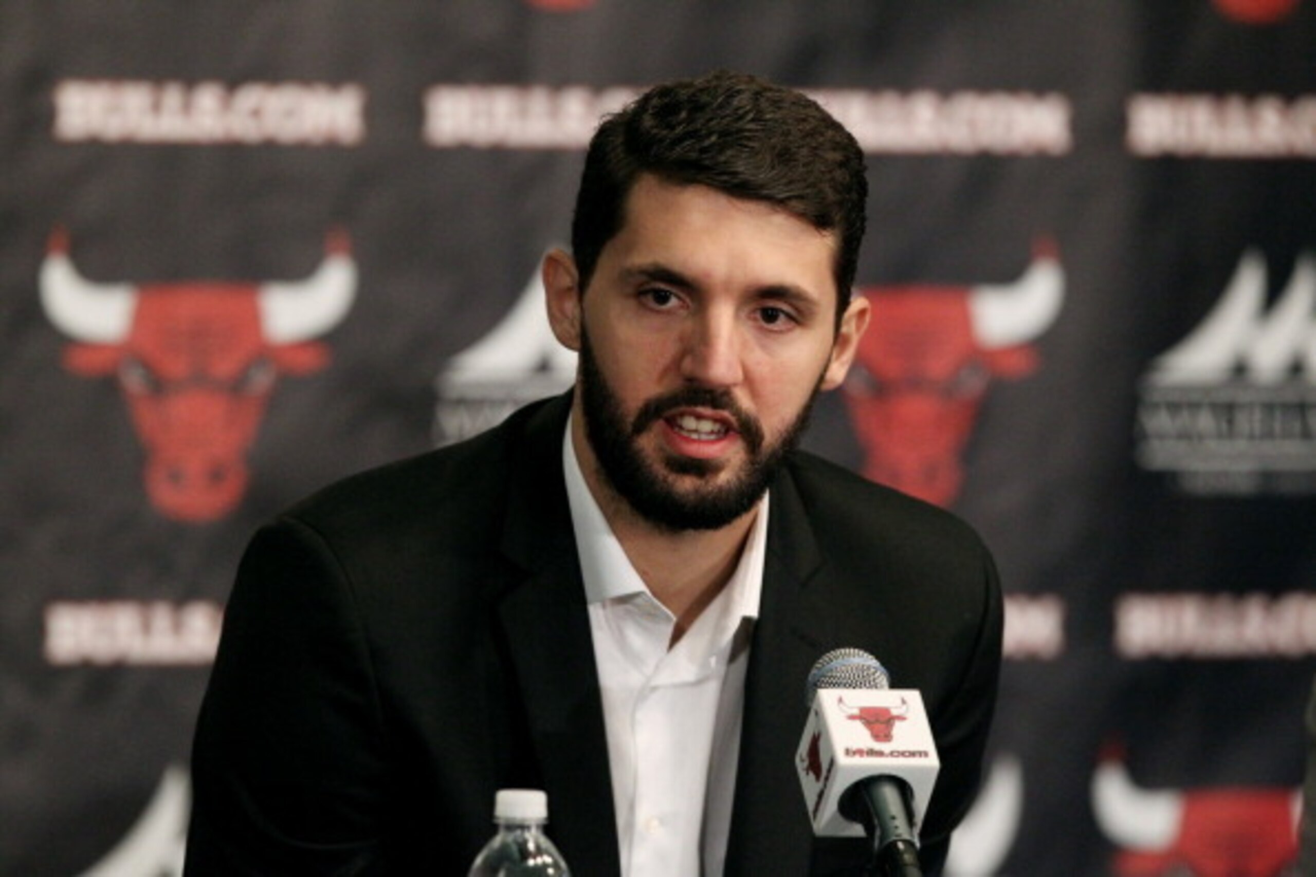 CHICAGO, IL - JULY 18: Chicago Bulls head coach Tom Thibodeau and general manager Gar Forman introduce newly-signed free agent Nikola Mirotic, accompanied by guest translator Igor Ormazabal, during a press conference at the United Center on July 18, 2014 