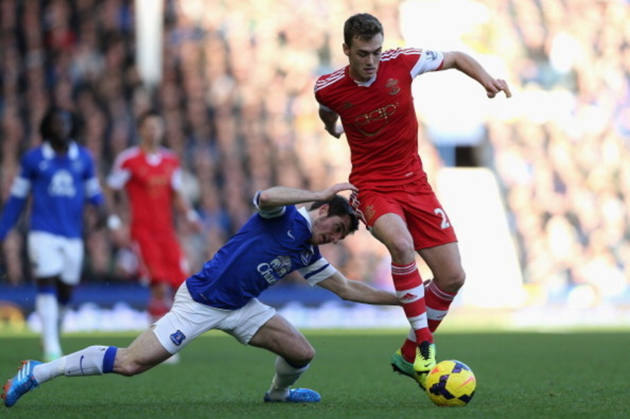 LIVERPOOL, ENGLAND - DECEMBER 29:  Calum Chambers of Southampton tangles with Leighton Baines of Everton during the Barclays Premier League match between Everton and Southampton at Goodison Park on December 29, 2013 in Liverpool, England.  (Photo by Clive