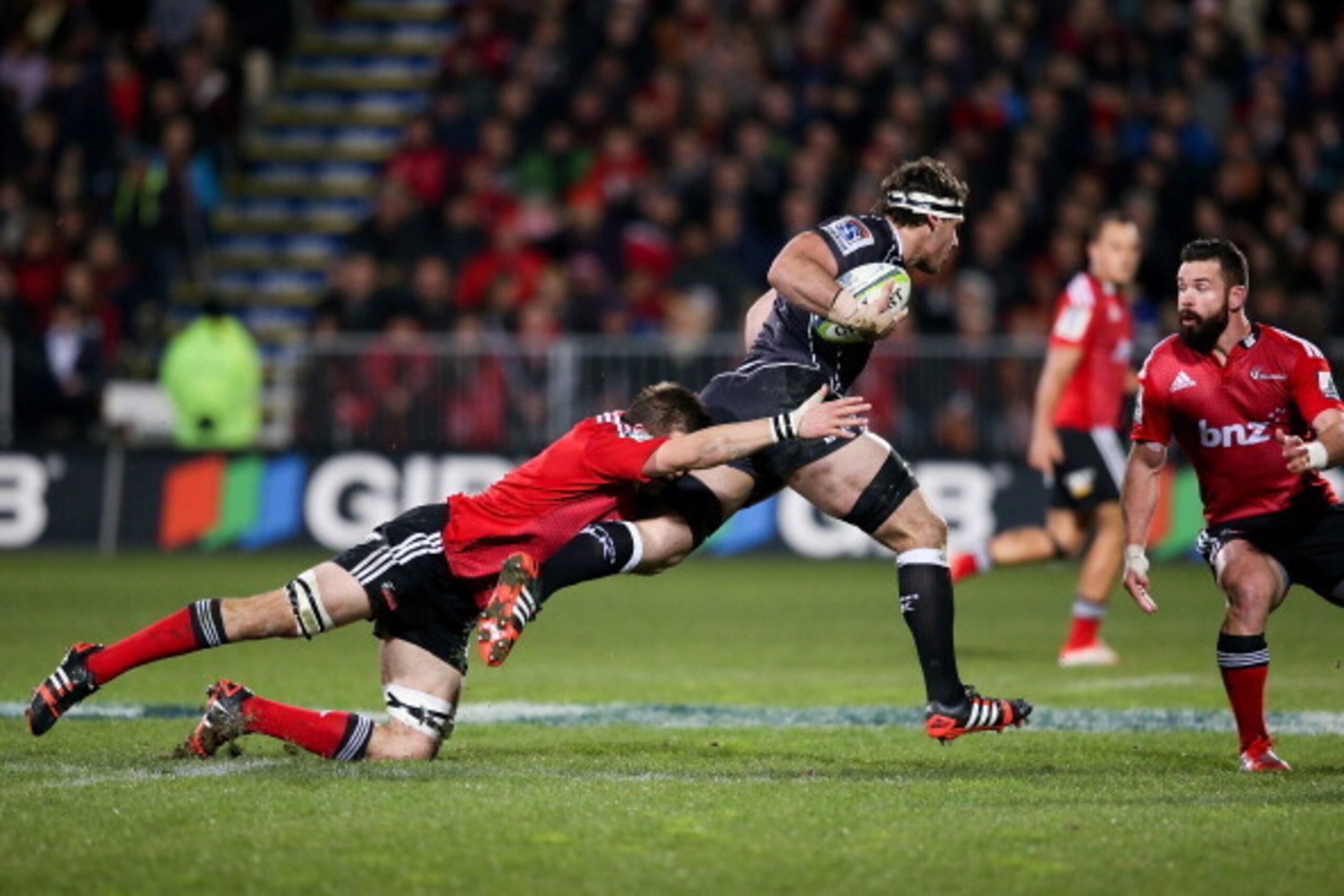 CHRISTCHURCH, NEW ZEALAND - JULY 26: Richie McCaw of the Crusaders makes a tackle on Marcell Coetzee of the Sharks during the Super Ruby Semi Final match between the Crusaders and the Sharks at AMI Stadium on July 26, 2014 in Christchurch, New Zealand.  (