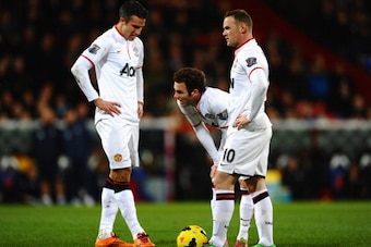 LONDON, ENGLAND - FEBRUARY 22: Robin Van Persie, Juan Mata and Wayne Rooney of Manchester United stand over a free kick during the Barclays Premier League match between Crystal Palace and Manchester United at Selhurst Park on February 22, 2014 in London, 