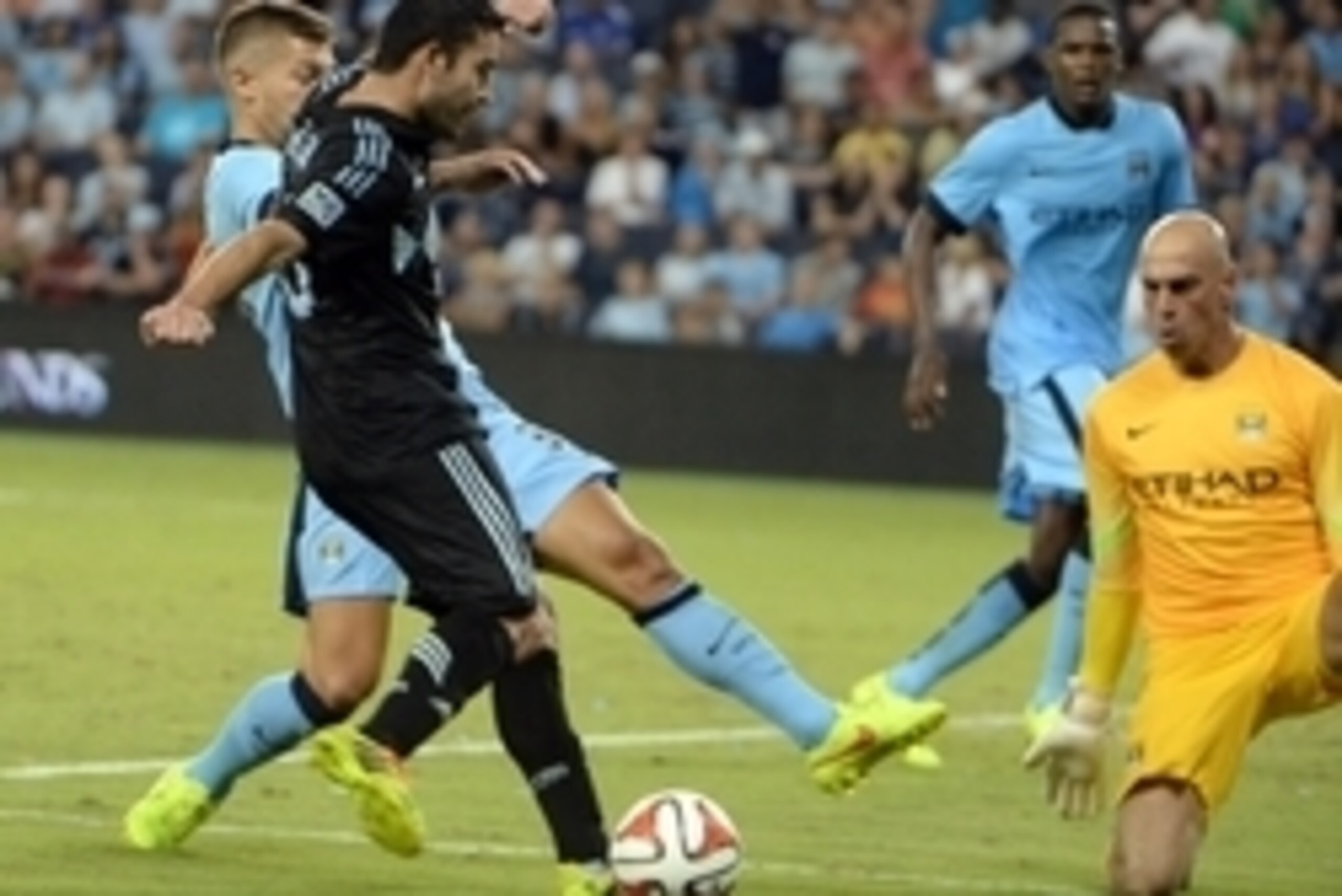 Jul 23, 2014; Kansas City, KS, USA; Sporting KC forward Claudio Bieler (16) moves towards goal against the Manchester City goal keeper Willy Caballero (13) in the second half at Sporting Park. Manchester City won 4-1. Mandatory Credit: John Rieger-USA TOD