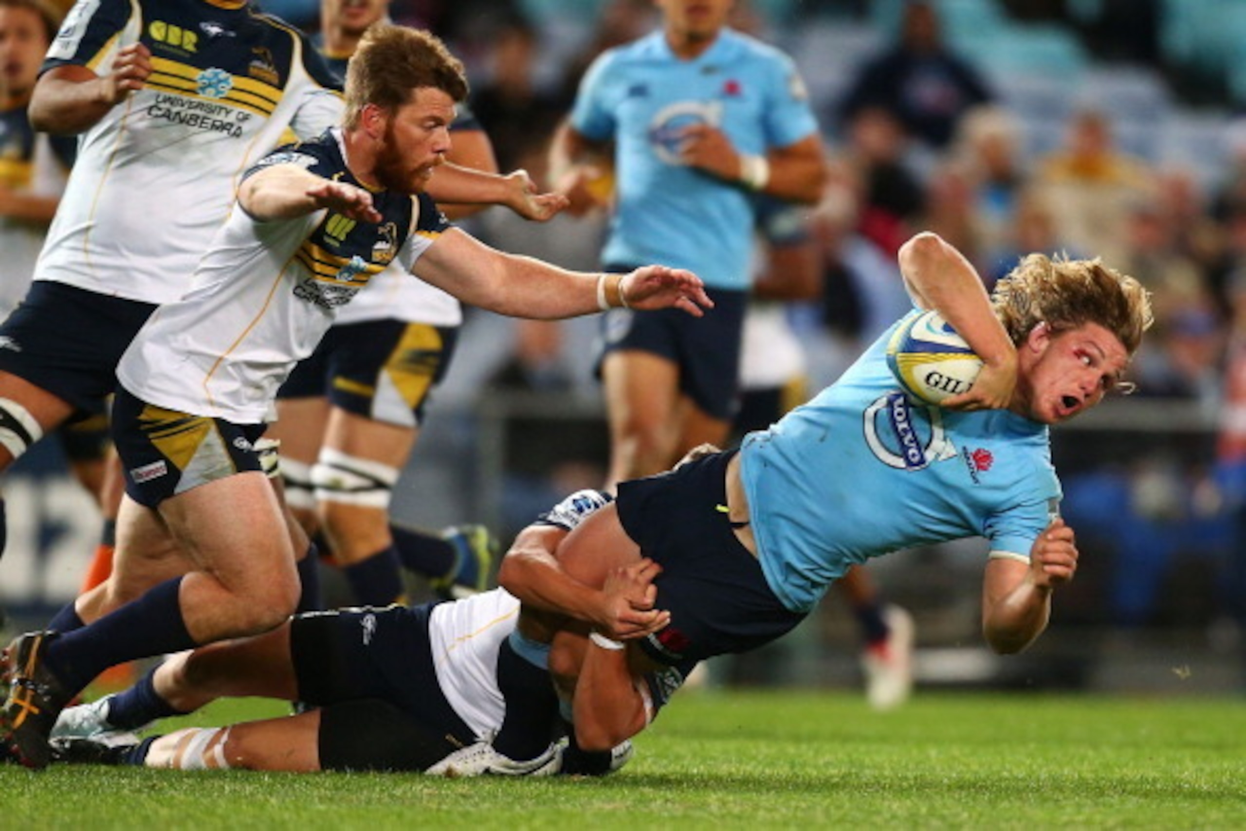 SYDNEY, AUSTRALIA - JUNE 28:  Michael Hooper of the Waratahs is tackled during the round 17 Super Rugby match between the Waratahs and the Brumbies at ANZ Stadium on June 28, 2014 in Sydney, Australia.  (Photo by Mark Nolan/Getty Images)