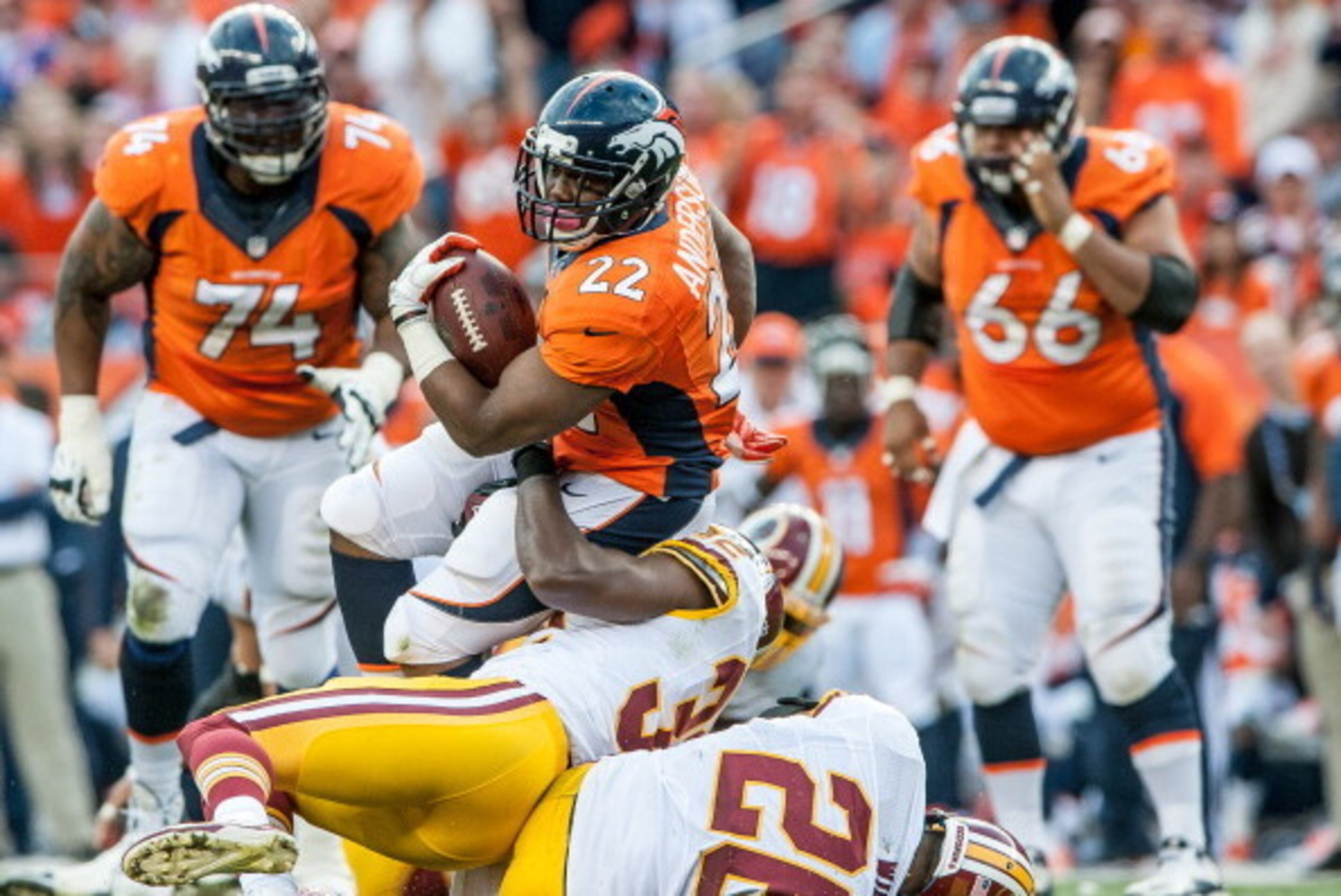 DENVER, CO - OCTOBER 27: Running Back C.J. Anderson #22 of the Denver Broncos is tackled by defensive back Jordan Pugh #32 of the Washington Redskins in the fourth quarter of a game at Sports Authority Field Field at Mile High on October 27, 2013 in Denv DENVER, CO - OCTOBER 27: Running Back C.J. Anderson #22 of the Denver Broncos is tackled by defensive back Jordan Pugh #32 of the Washington Redskins in the fourth quarter of a game at Sports Authority Field Field at Mile High on October 27, 2013 in Denv