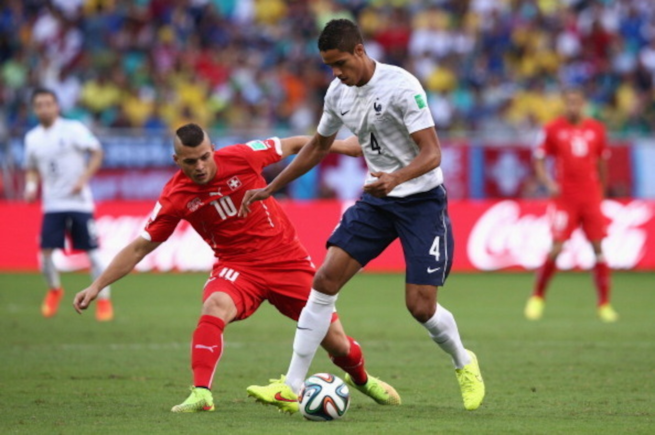 SALVADOR, BRAZIL - JUNE 20: Raphael Varane of France controls the ball against Granit Xhaka of Switzerland during the 2014 FIFA World Cup Brazil Group E match between Switzerland and France at Arena Fonte Nova on June 20, 2014 in Salvador, Brazil.  (Photo