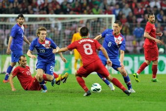 GENEVA, SWITZERLAND - JUNE 10:  Alen Halilovic and Arijan Ademi of Croatia fights for the ball with Joao Moutinho of Portugal during the international friendly match between Portugal and Croatia on June 10, 2013 in Geneva, Switzerland.  (Photo by Harold C