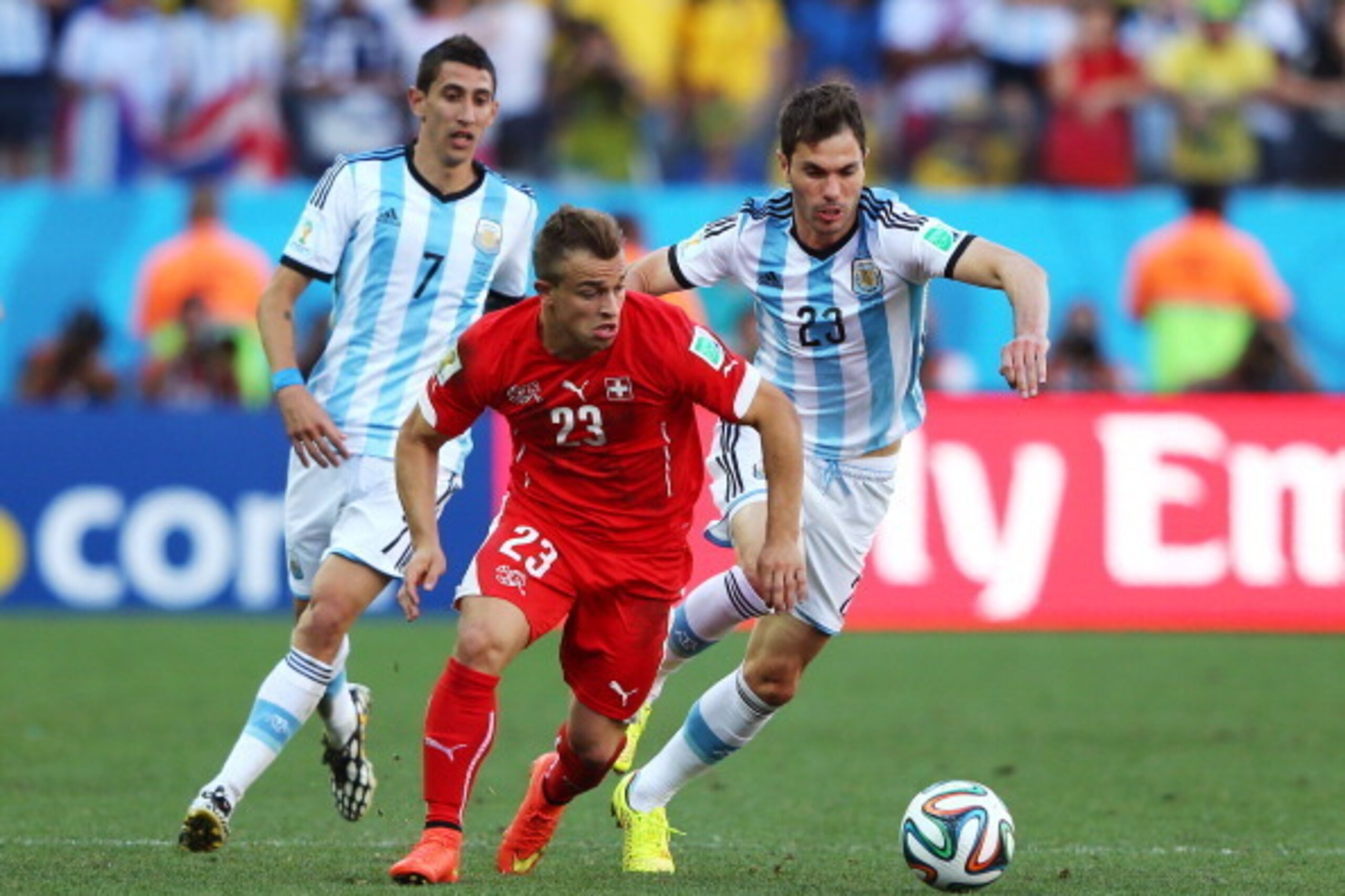SAO PAULO, BRAZIL - JULY 01: Xherdan Shaqiri of Switzerland is challenged by Angel di Maria (L) and Jose Maria Basanta of Argentina during the 2014 FIFA World Cup Brazil Round of 16 match between Argentina and Switzerland at Arena de Sao Paulo on July 1 SAO PAULO, BRAZIL - JULY 01: Xherdan Shaqiri of Switzerland is challenged by Angel di Maria (L) and Jose Maria Basanta of Argentina during the 2014 FIFA World Cup Brazil Round of 16 match between Argentina and Switzerland at Arena de Sao Paulo on July 1