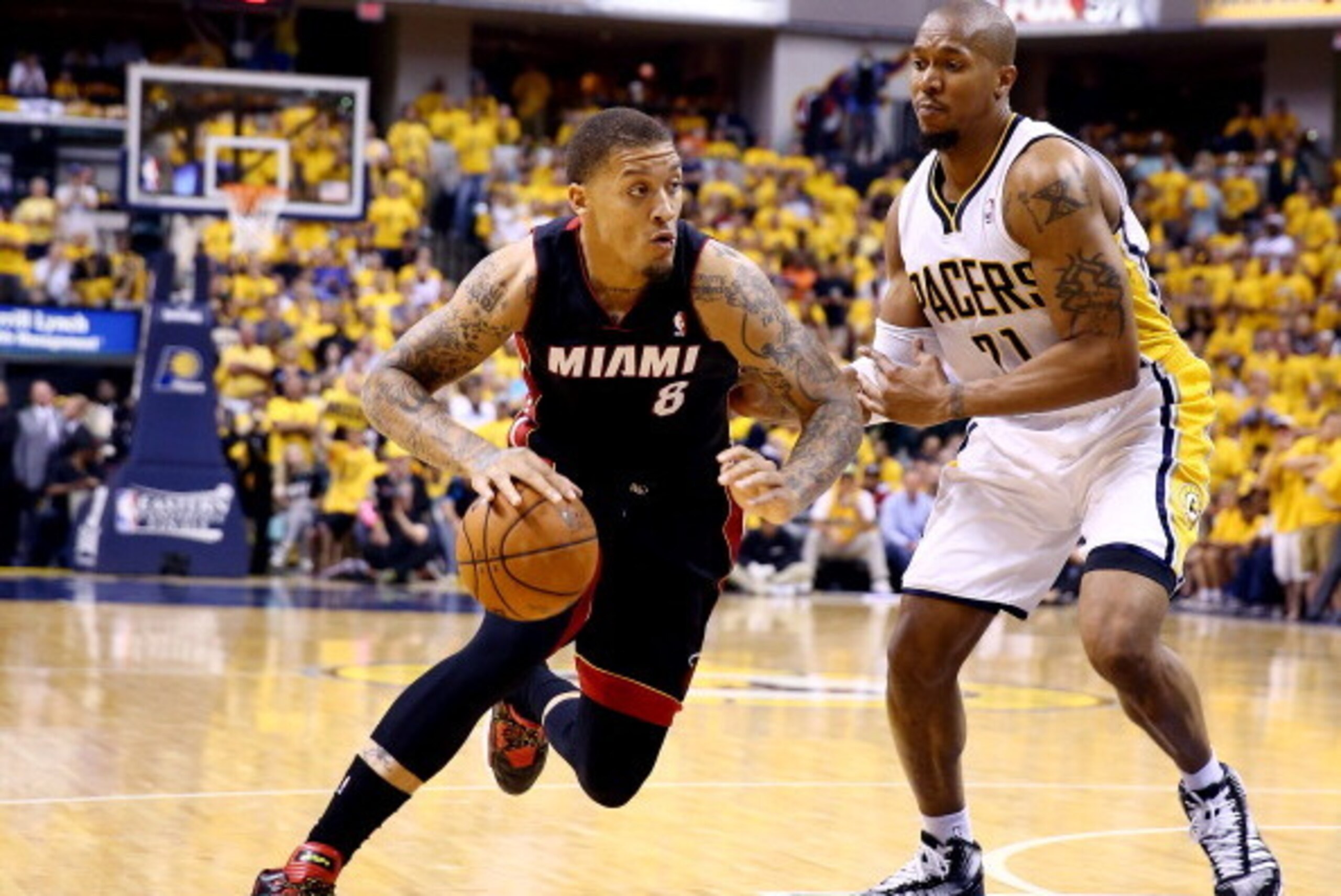 INDIANAPOLIS, IN - MAY 28:  Michael Beasley #8 of the Miami Heat drives to the basket against David West #21 of the Indiana Pacers during Game Five of the Eastern Conference Finals of the 2014 NBA Playoffs at Bankers Life Fieldhouse on May 28, 2014 in Ind