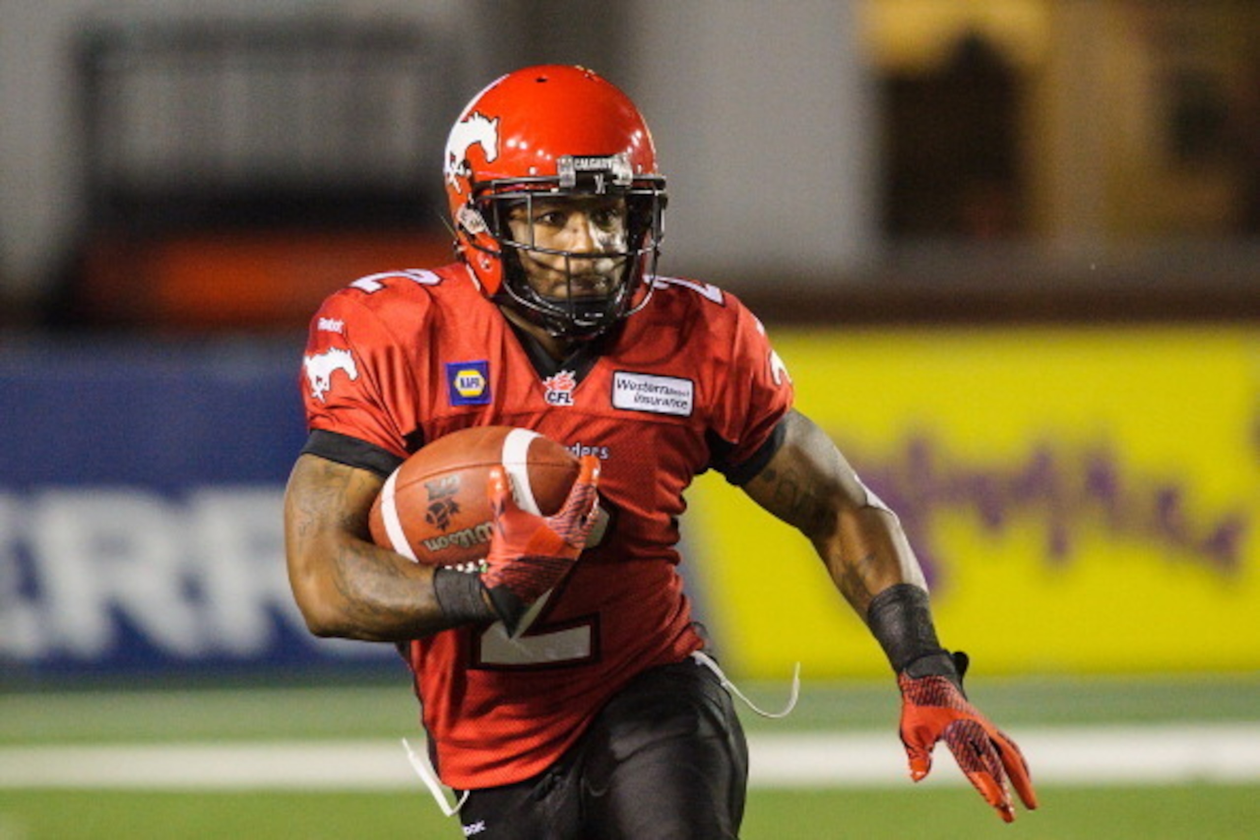 CALGARY, AB - JULY 18: Jock Sanders #2 of the Calgary Stampeders runs the ball against the Hamilton Tiger-Cats during a CFL game at McMahon Stadium on July 18, 2014 in Calgary, Alberta, Canada. The Stampeders defeated the Tiger-Cats 10-7.  (Photo by Derek