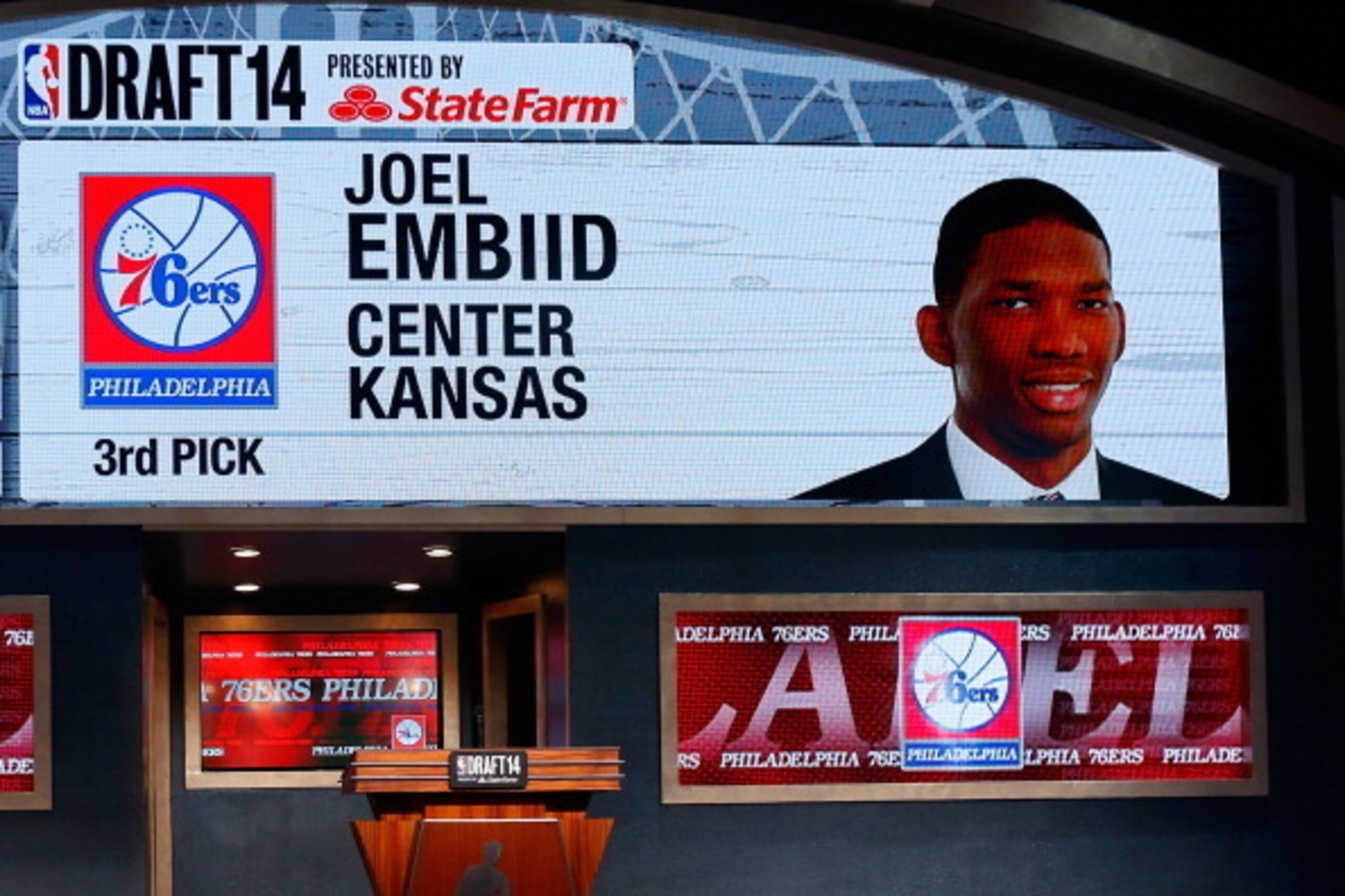 NEW YORK, NY - JUNE 26:  A video screen shows the selection of Joel Embiid of Kansas as the #3 overall pick in the first round by the Philadelphia 76ers during the 2014 NBA Draft at Barclays Center on June 26, 2014 in the Brooklyn borough of New York City
