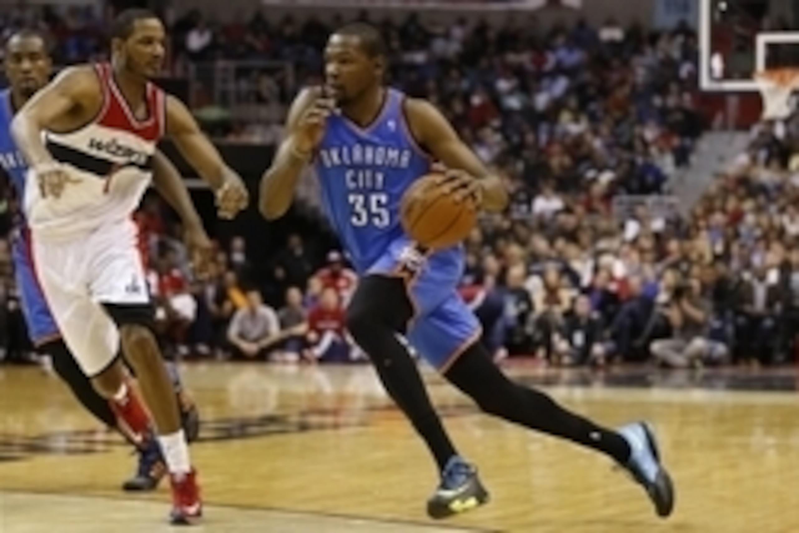 Feb 1, 2014; Washington, DC, USA; Oklahoma City Thunder small forward Kevin Durant (35) dribbles the ball past Washington Wizards small forward Trevor Ariza (1) in the third quarter at Verizon Center. The Wizards won 96-81. Mandatory Credit: Geoff Burke-U