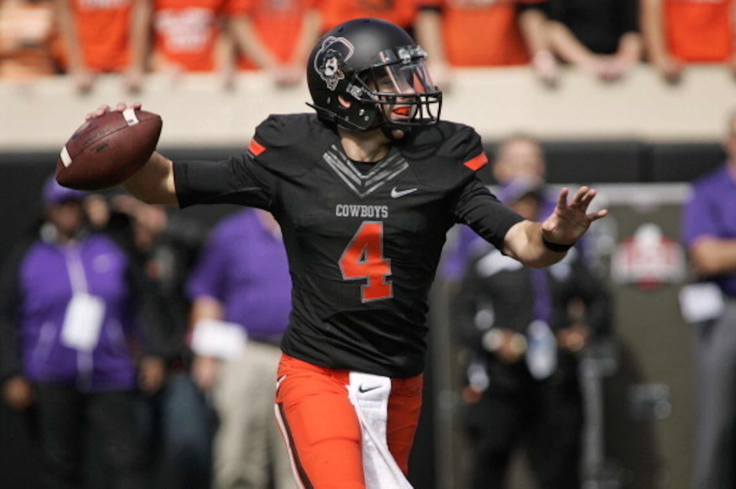 STILLWATER, OK - OCTOBER 5:   Quarterback J.W. Walsh #4 of the Oklahoma State Cowboys looks to throw against the Kansas State Wildcats October 5, 2013 at Boone Pickens Stadium in Stillwater, Oklahoma. The Cowboys defeated the Wildcats 33-29.  (Photo by Br