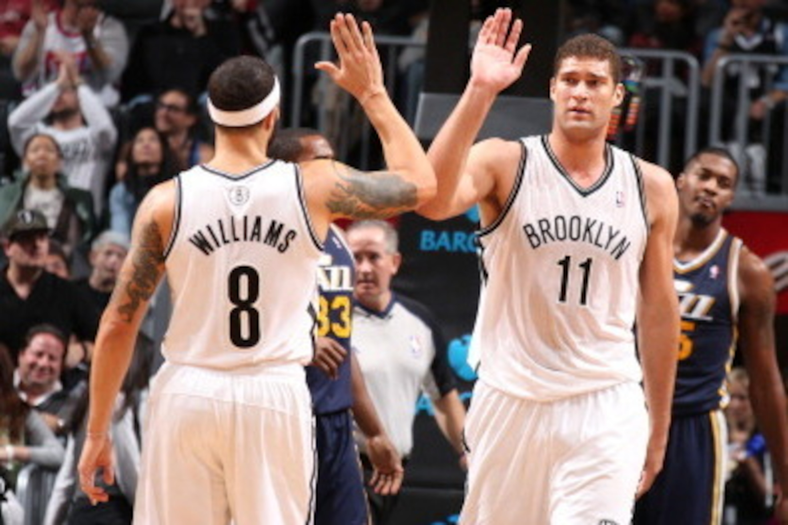 NEW YORK, NY - NOVEMBER 5: Teammates Deron Williams #8 of the Brooklyn Nets and Brook Lopez #11 of the Brooklyn Nets high five during a game against the Utah Jazz at Barclays Center on November 5, 2013 in the Brooklyn borough of New York City.  NOTE TO US