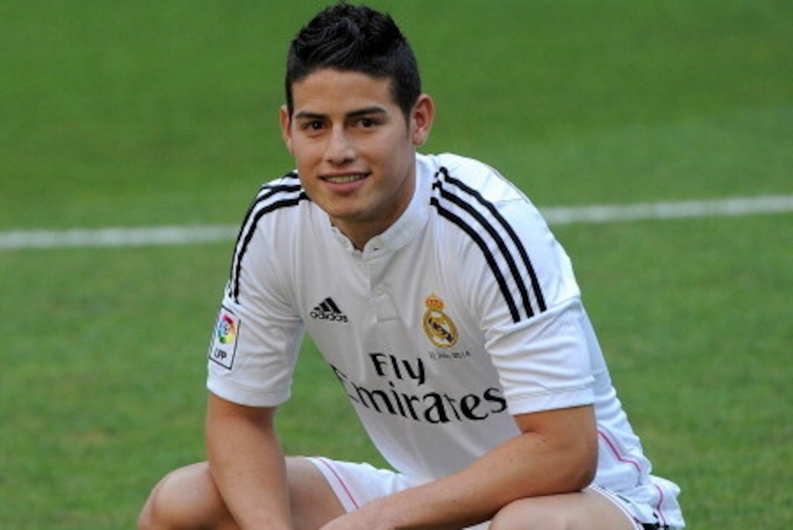 MADRID, SPAIN - JULY 22:  James Rodriguez poses for photographers during his unveiling as a new Real Madrid player at the Santaigo Bernabeu stadium on July 22, 2014 in Madrid, Spain. Real agreed to buy Rodriguez from AS Monaco for the next six seasons for