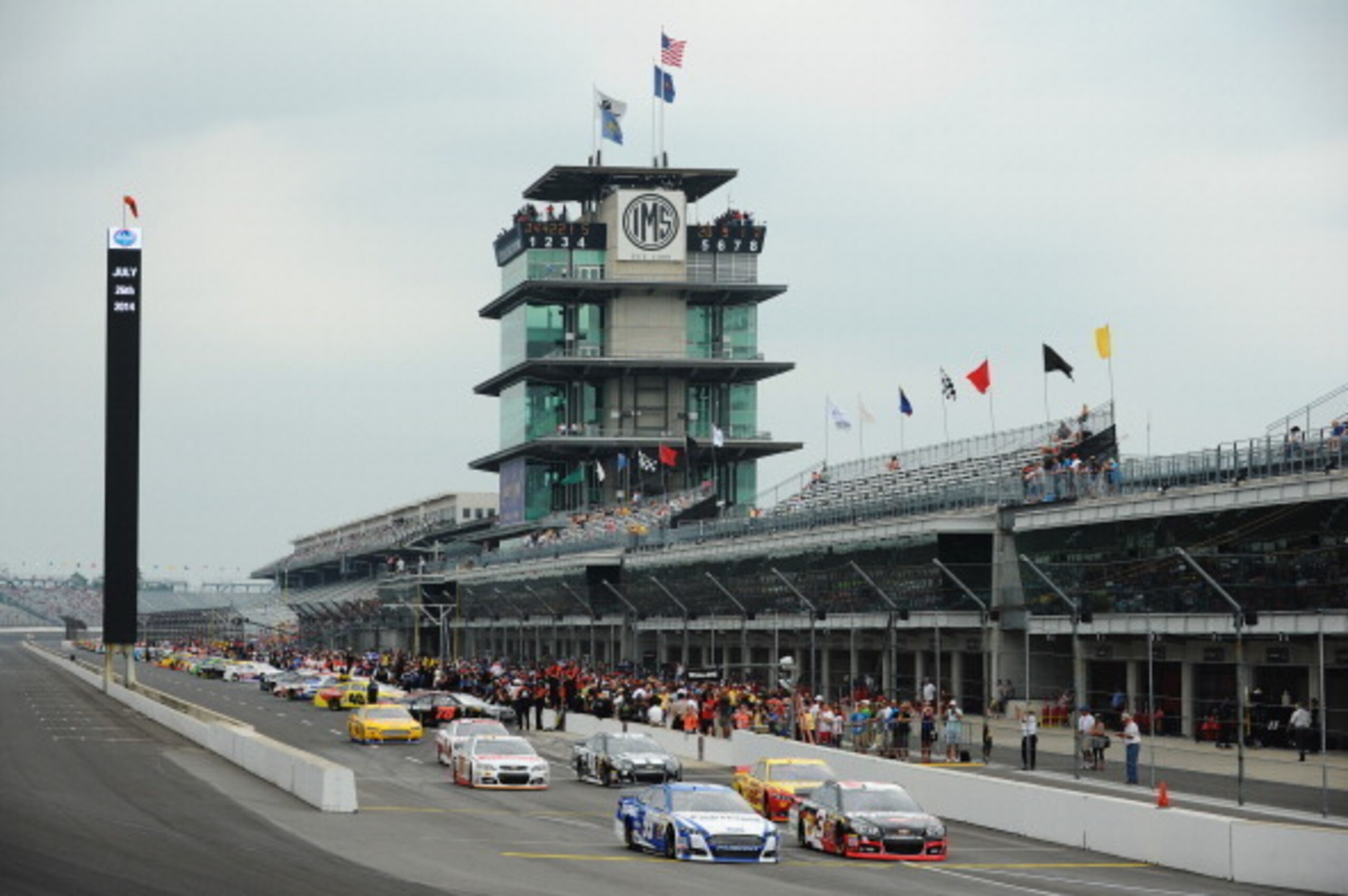 INDIANAPOLIS, IN - JULY 26:  Carl Edwards, driver of the #99 Fastenal Ford, and Austin Dillon, driver of the #3 Dow - Mycogen Seeds Chevrolet, lead the field out of the pits during qualifying for the NASCAR Sprint Cup Series Crown Royal Presents The John 