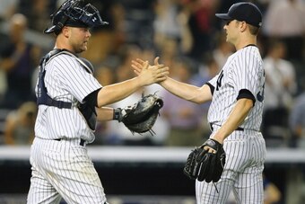 NEW YORK, NY - JUNE 17:  David Robertson #30 and Brian McCann #34 of the New York Yankees celebrate a 3-1 win against the Toronto Blue Jays during their game at Yankee Stadium on June 17, 2014 in the Bronx borough of New York City.  (Photo by Al Bello/Get