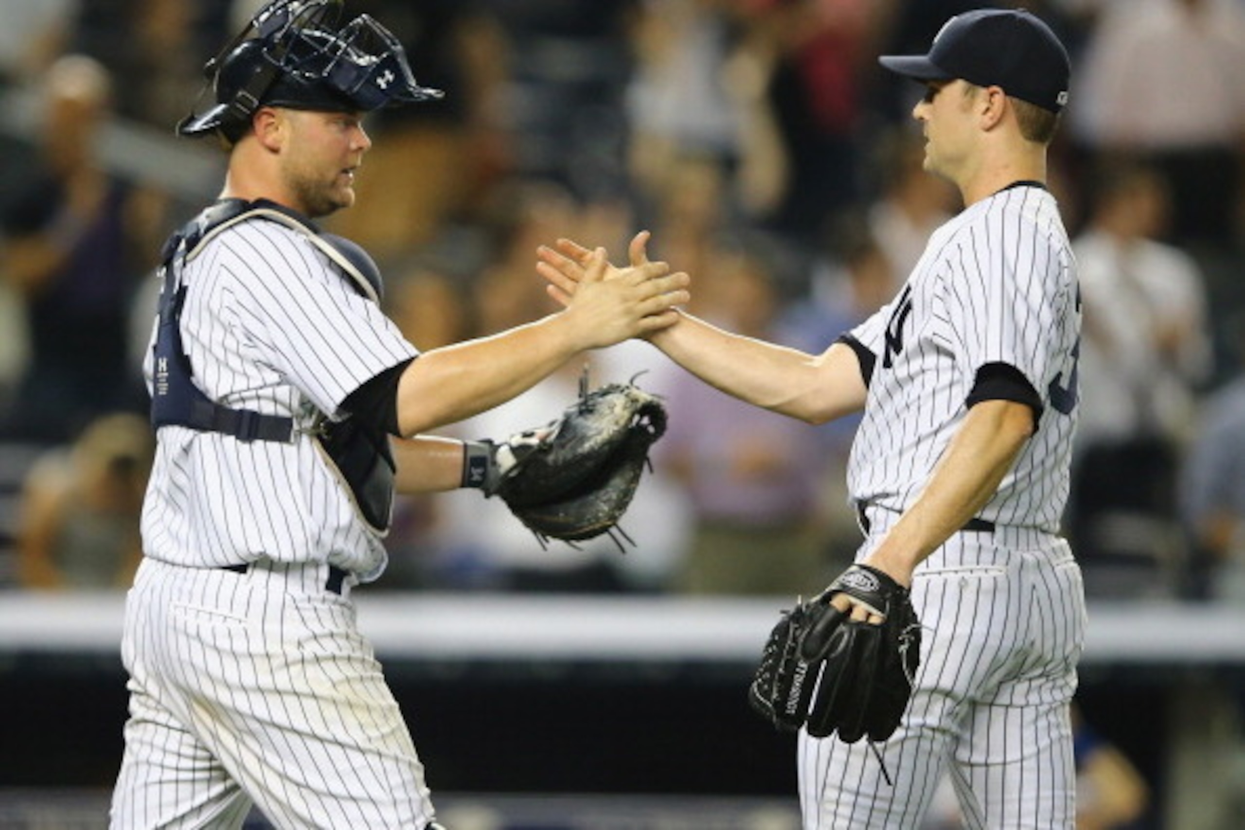NEW YORK, NY - JUNE 17:  David Robertson #30 and Brian McCann #34 of the New York Yankees celebrate a 3-1 win against the Toronto Blue Jays during their game at Yankee Stadium on June 17, 2014 in the Bronx borough of New York City.  (Photo by Al Bello/Get