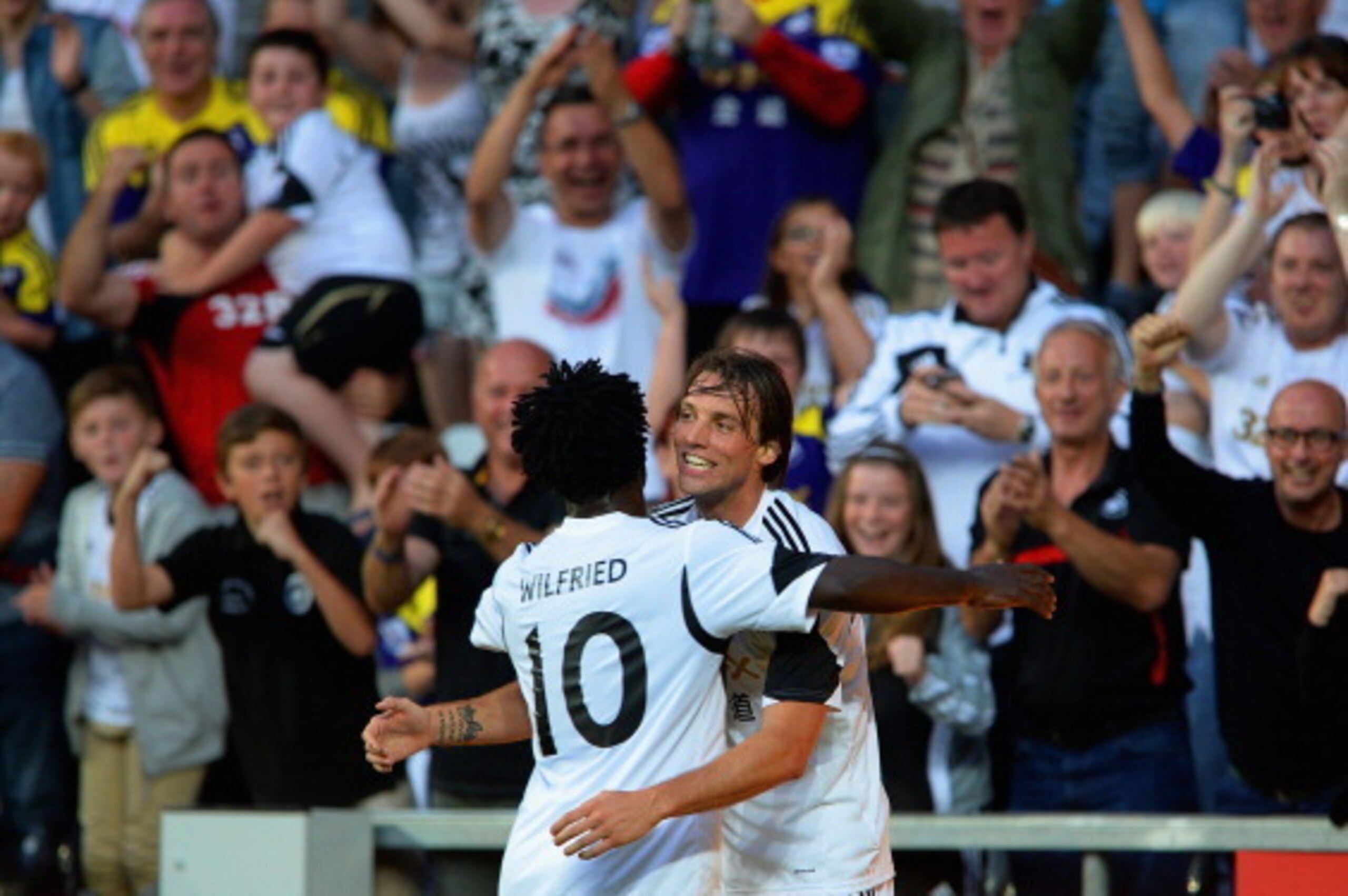 SWANSEA, WALES - AUGUST 01: Wilfried Bony celebrates scoring his 2nd to make it 3-0 with Michu during the UEFA Europa League third round qualifying first leg match between Swansea City and Malmo at the Liberty Stadium on August 1, 2013 in Swansea, Wales. 