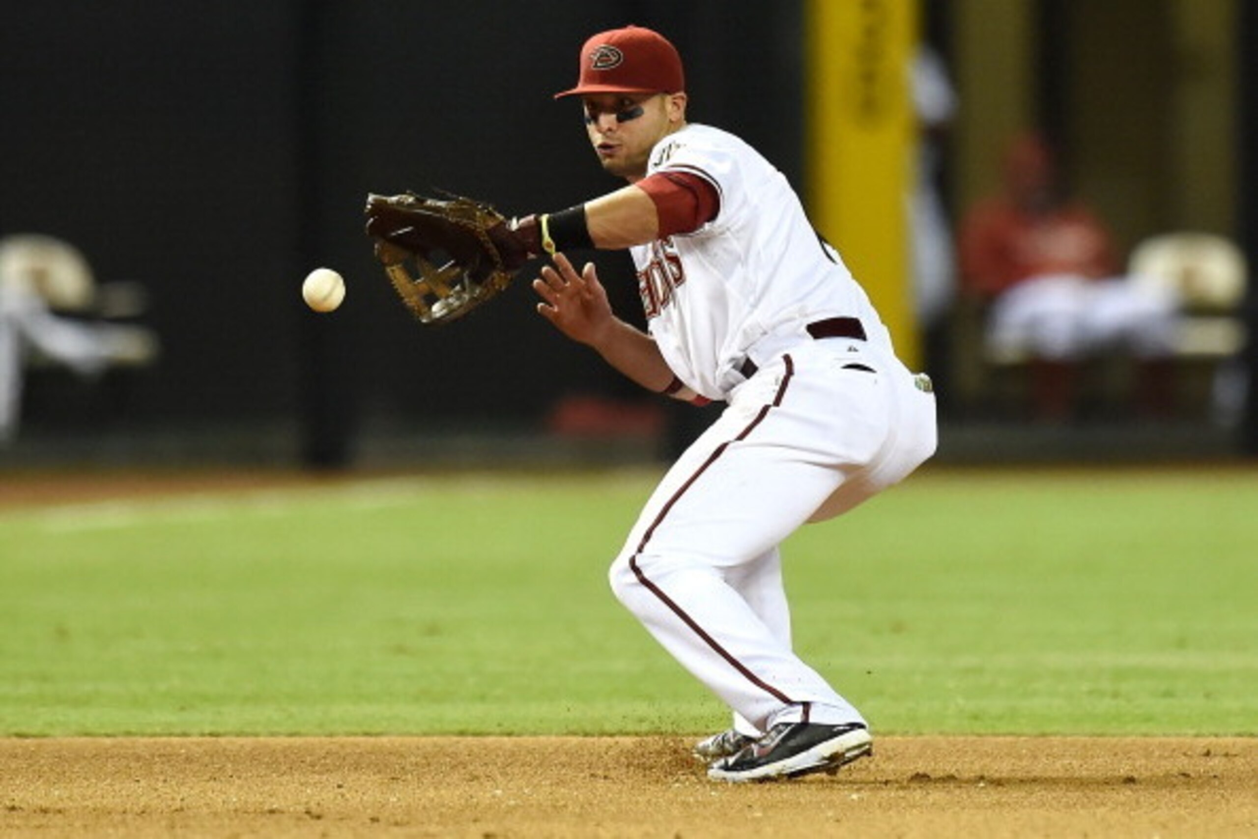 PHOENIX, AZ - JULY 21:  Martin Prado #14 of the Arizona Diamondbacks fields the ball during the eighth inning against the Detroit Tigers at Chase Field on July 21, 2014 in Phoenix, Arizona. Detroit won 4-3. (Photo by Norm Hall/Getty Images)