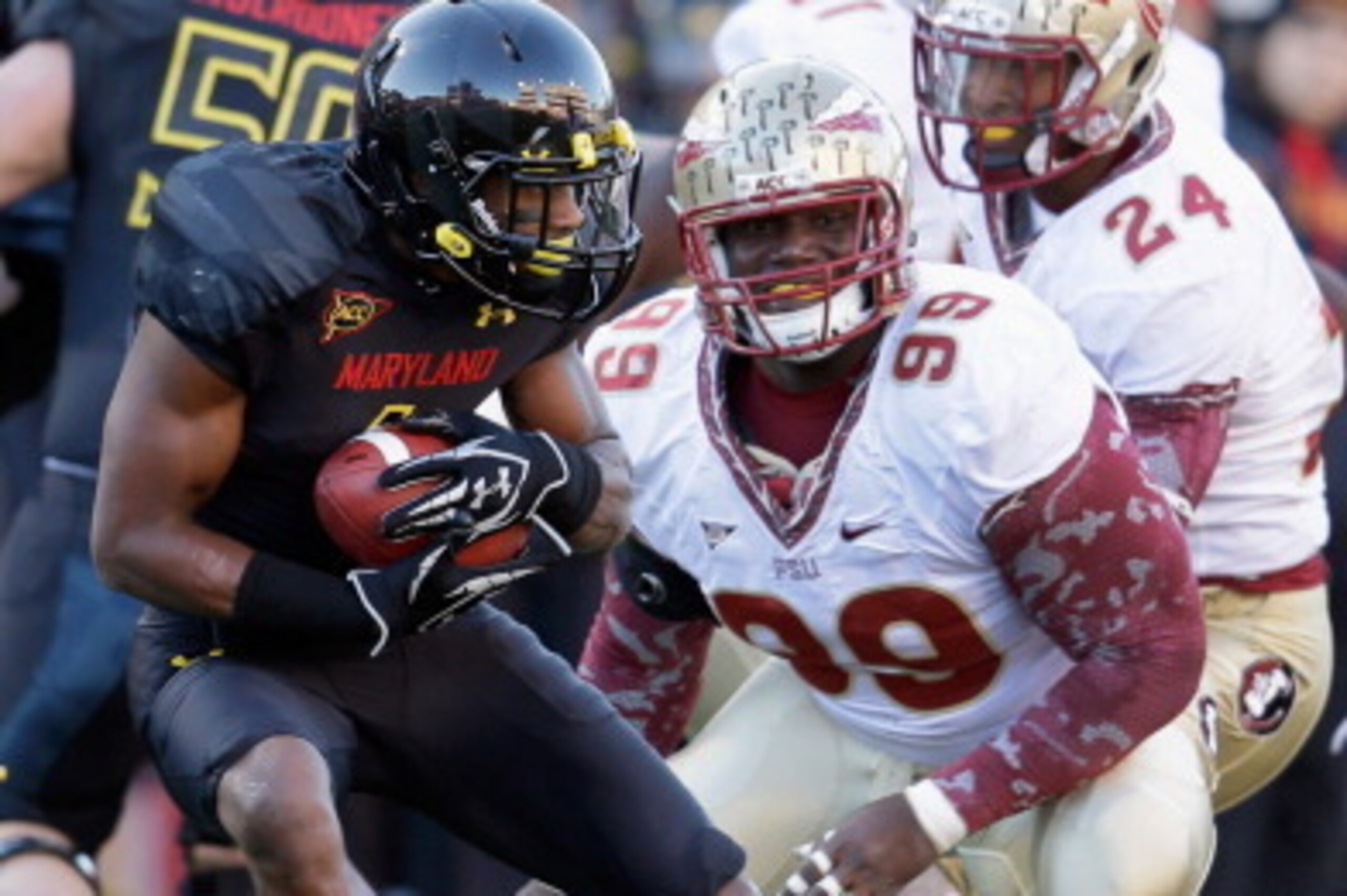 COLLEGE PARK, MD - NOVEMBER 17: Defensive tackle Nile Lawrence-Stample #99 of the Florida State Seminoles moves in to tackle wide receiver Stefon Diggs #1 of the Maryland Terrapins during the fourth quarter of the Seminoles 41-14 win at Byrd Stadium on No