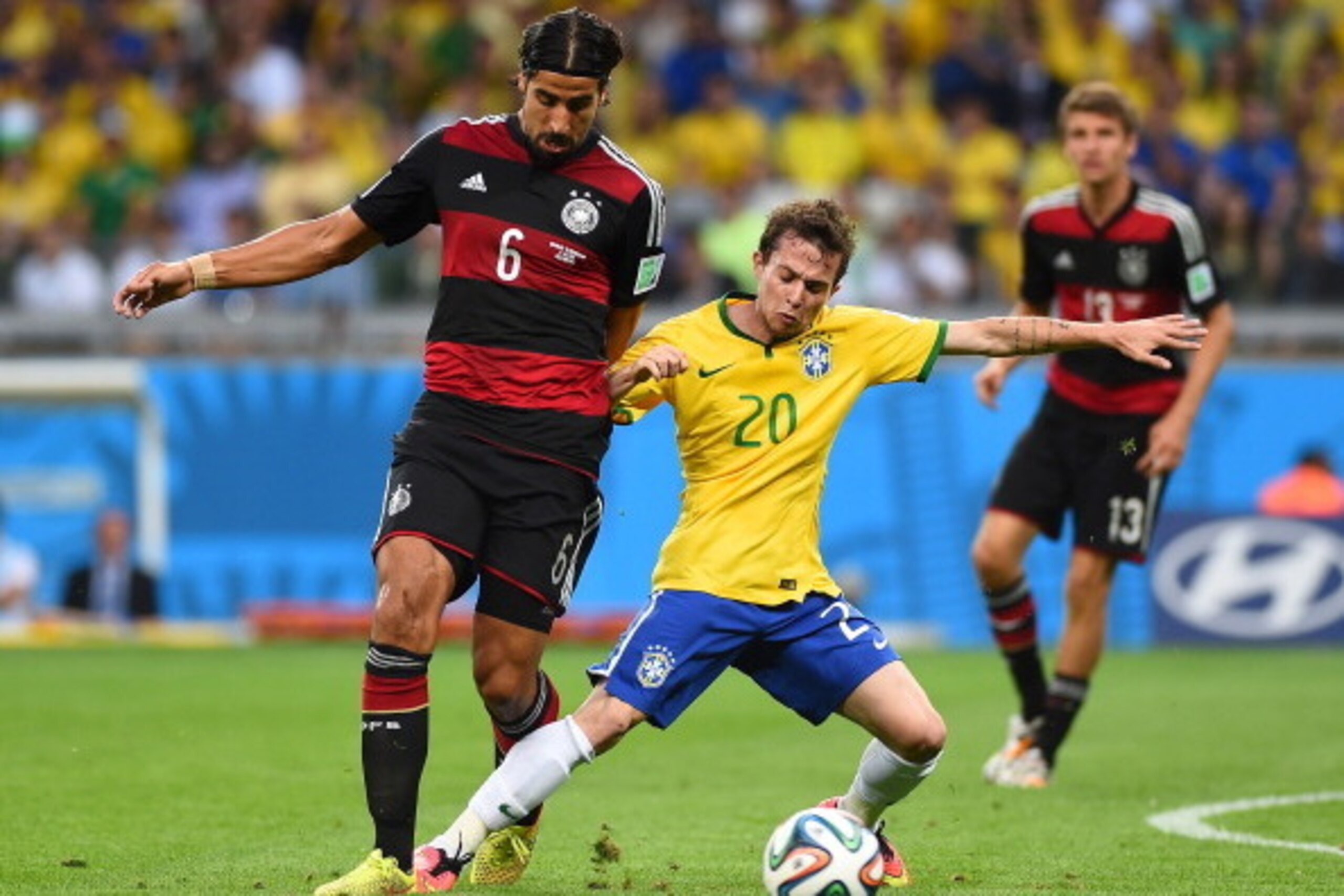 BELO HORIZONTE, BRAZIL - JULY 08:  Bernard of Brazil is challenged by Sami Khedira of Germany during the 2014 FIFA World Cup Brazil Semi Final match between Brazil and Germany at Estadio Mineirao on July 8, 2014 in Belo Horizonte, Brazil.  (Photo by Laure