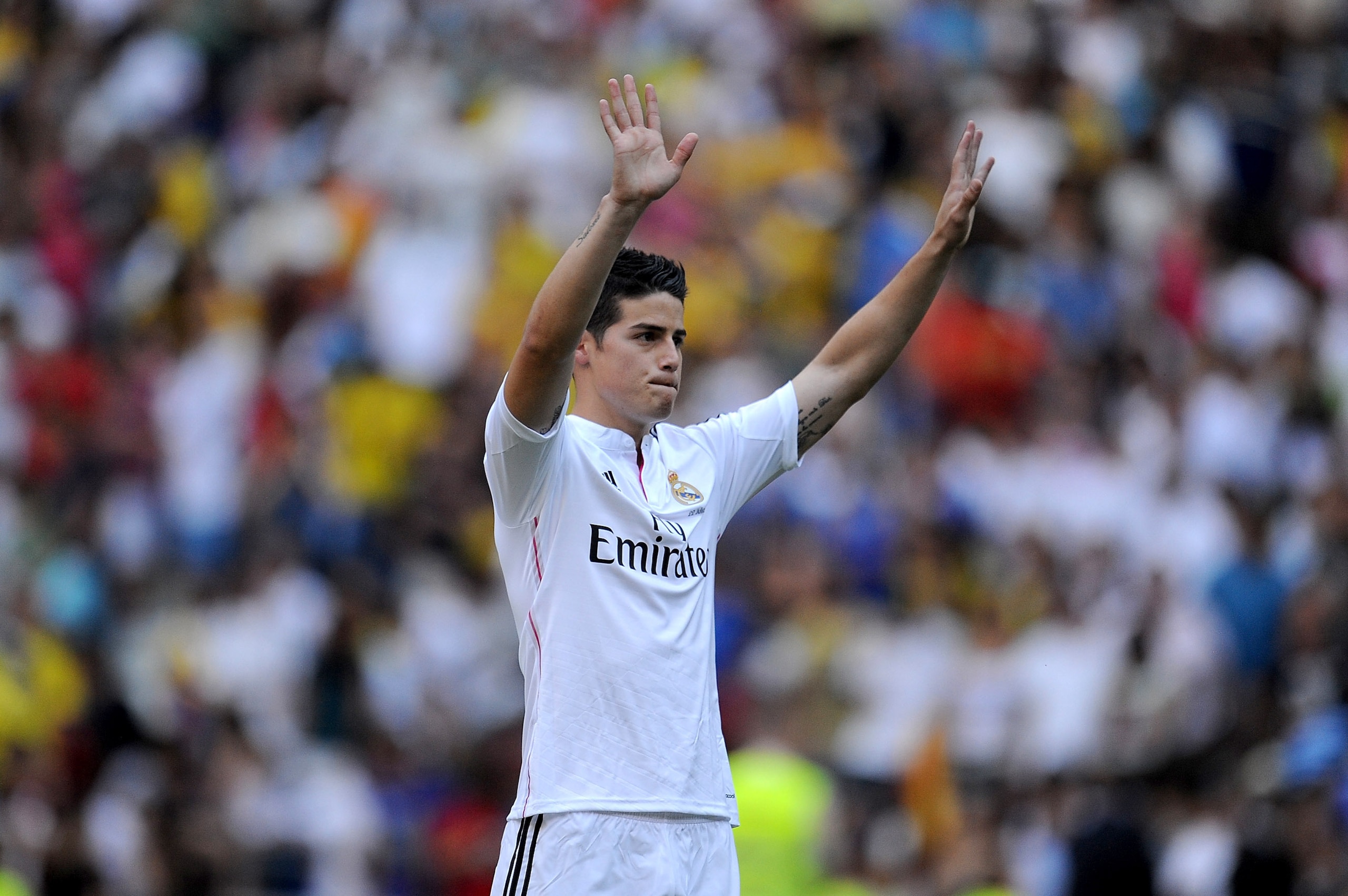 MADRID, SPAIN - JULY 22:  James Rodriguez waves to fans during his unveiling as a new Real Madrid player at the Santaigo Bernabeu stadium on July 22, 2014 in Madrid, Spain. Real agreed to buy Rodriguez from AS Monaco for the next six seasons for an undisc