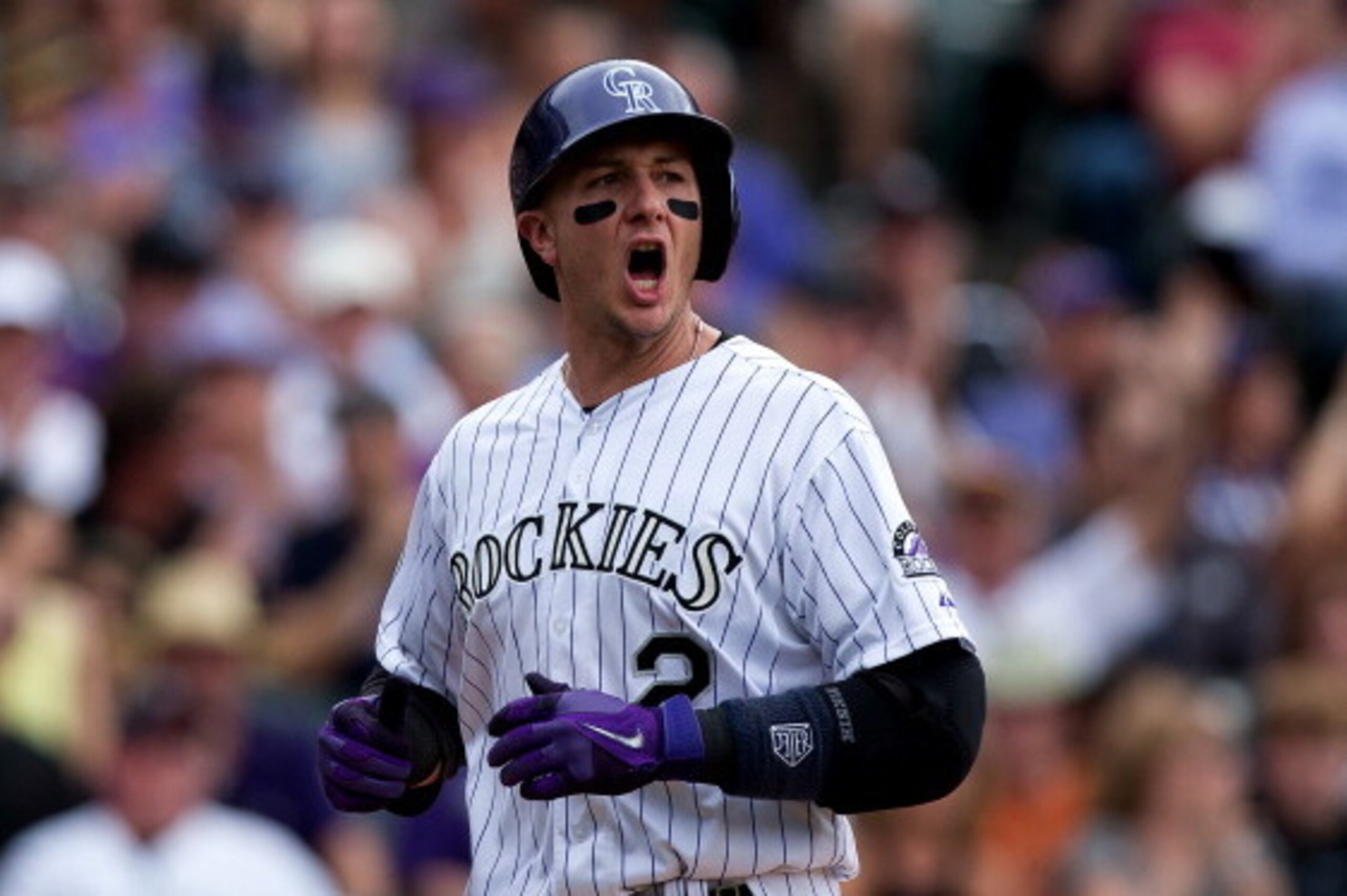 DENVER, CO - MAY 18:  Troy Tulowitzki #2 of the Colorado Rockies celebrates after scoring on a single by Carlos Gonzalez (not pictured) during the seventh inning against the San Diego Padres at Coors Field on May 18, 2014 in Denver, Colorado. The Rockies 