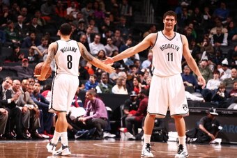 NEW YORK, NY - DECEMBER 18: Deron Williams #8 of the Brooklyn Nets high fives teammate Brook Lopez #11 during a game against  the Washington Wizards at the Barclays Center on December 18, 2013 in the Brooklyn borough of New York City.  NOTE TO USER: User 