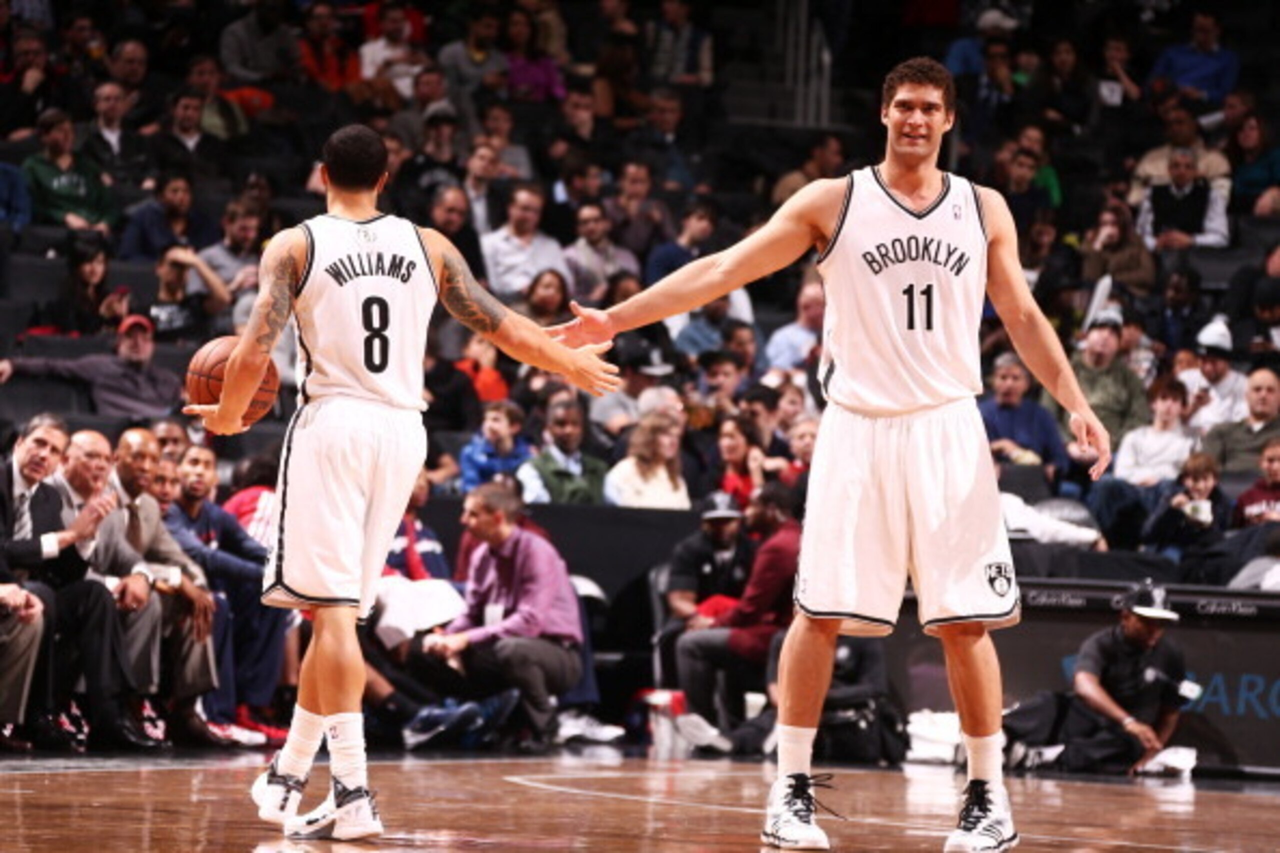 NEW YORK, NY - DECEMBER 18: Deron Williams #8 of the Brooklyn Nets high fives teammate Brook Lopez #11 during a game against  the Washington Wizards at the Barclays Center on December 18, 2013 in the Brooklyn borough of New York City.  NOTE TO USER: User 