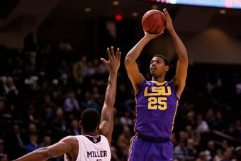 Feb 12, 2014; College Station, TX, USA; LSU Tigers forward Jordan Mickey (25) shoots the ball over Texas A&M Aggies forward Tavario Miller (4) during the first half at Reed Arena. Mandatory Credit: Soobum Im-USA TODAY Sports