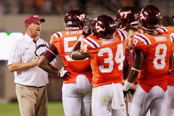 BLACKSBURG, VA - SEPTEMBER 03:  Defensive coordinator Bud Foster (l) of the Virginia Tech Hokies talks to his players against the Georgia Tech Yellow Jackets at Lane Stadium on September 3, 2012 in Blacksburg, Virginia.  (Photo by Geoff Burke/Getty Images