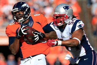 DENVER, CO - JANUARY 19:  Julius Thomas #80 of the Denver Broncos runs with the ball against Dont'a Hightower #54 of the New England Patriots during the AFC Championship game at Sports Authority Field at Mile High on January 19, 2014 in Denver, Colorado. 