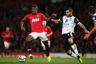 MANCHESTER, ENGLAND - OCTOBER 29:  Wilfried Zaha of Manchester United is challenged by Bradley Johnson of Norwich City during the Capital One Cup fourth round match between Manchester United and Norwich City at Old Trafford on October 29, 2013 in Manchest