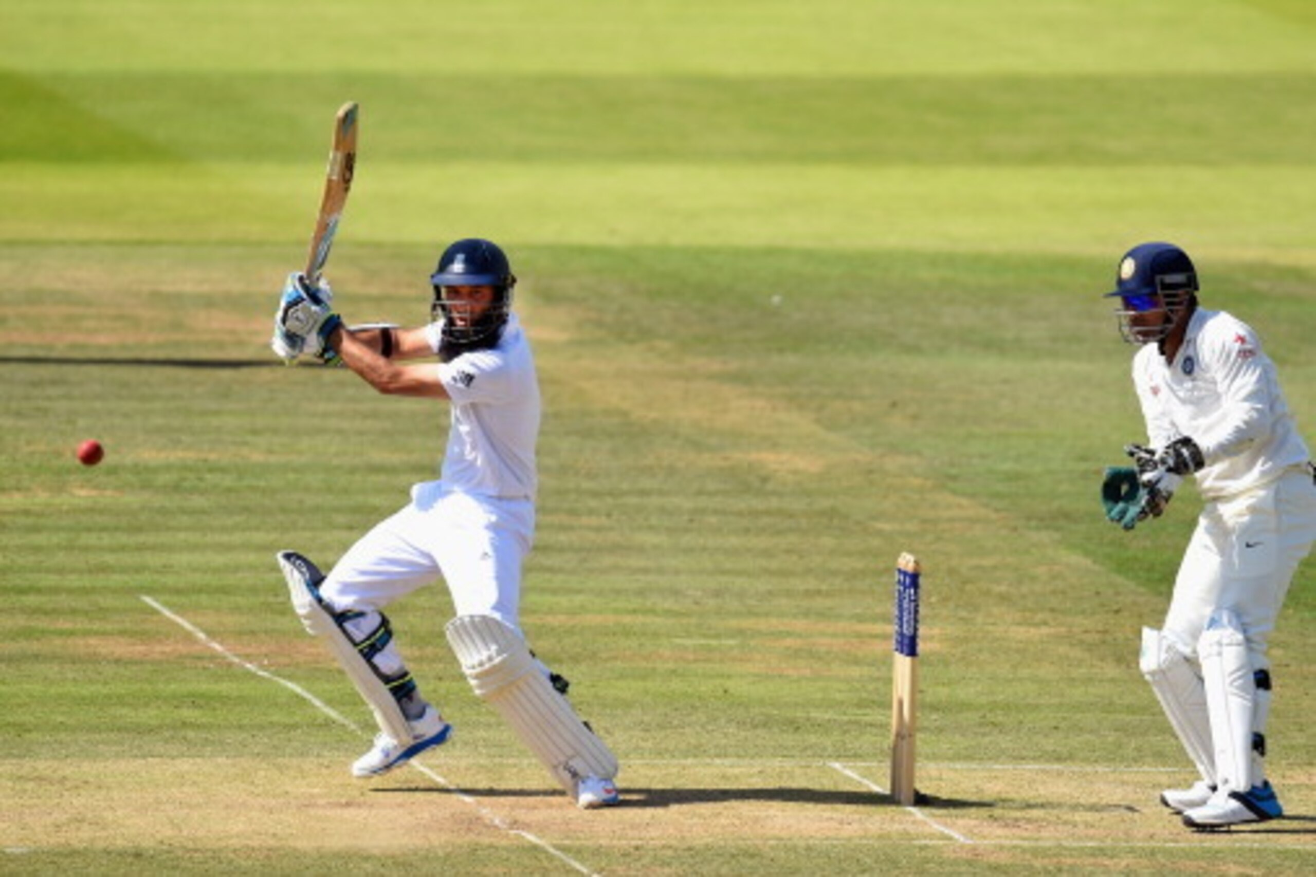 LONDON, ENGLAND - JULY 18:  England batsman Moeen Ali picks up runs watched by India wicketkeeper M.S. Dhoni during day two of 2nd Investec Test match between England and India at Lord's Cricket Ground on July 18, 2014 in London, United Kingdom.  (Photo b