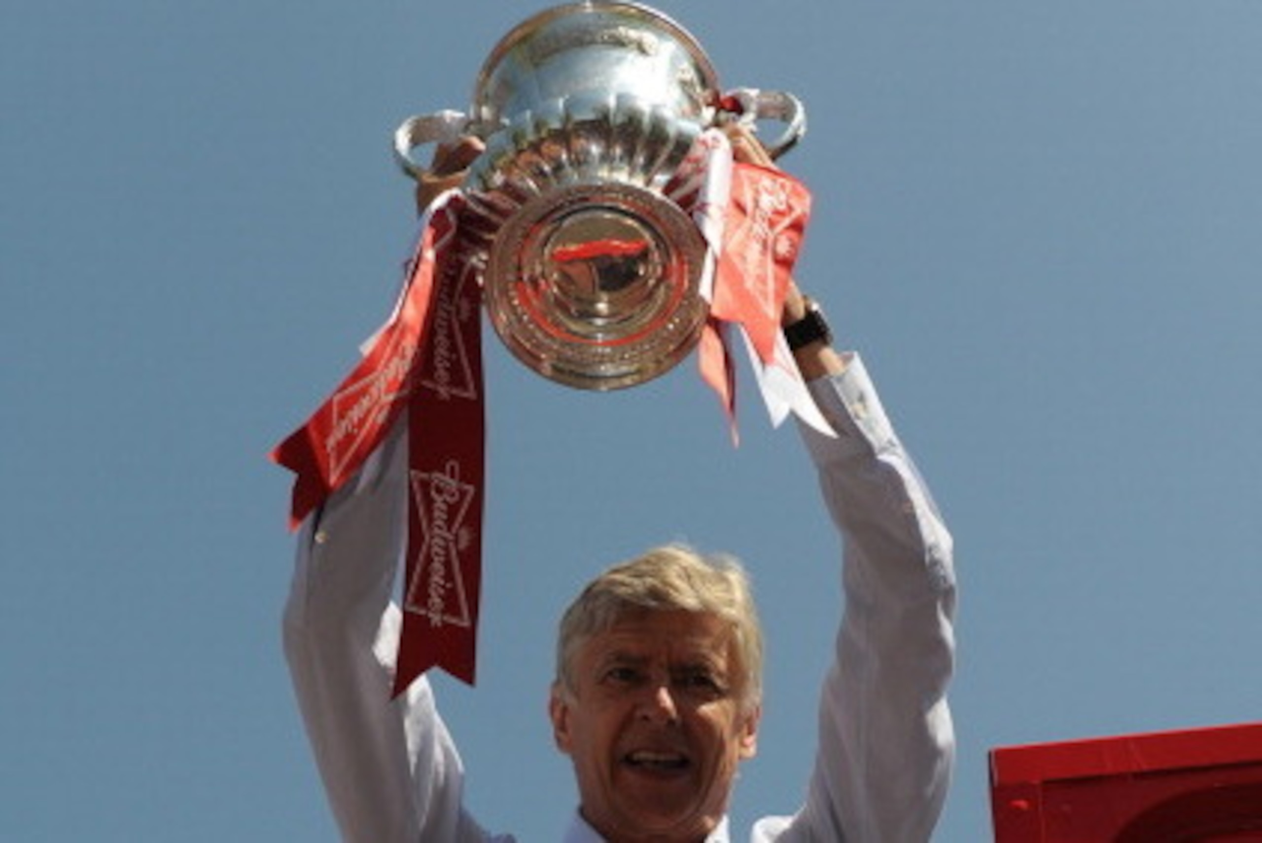 LONDON, ENGLAND - MAY 18: Arsene Wenger, manager of Arsenal FC celebrates with the FA Cup on board the Arsenal team bus during the Arsenal FA Cup Victory Parade in Islington, London on May 18, 2014 in London, England. (Photo by Steve Bardens/Getty Images) LONDON, ENGLAND - MAY 18: Arsene Wenger, manager of Arsenal FC celebrates with the FA Cup on board the Arsenal team bus during the Arsenal FA Cup Victory Parade in Islington, London on May 18, 2014 in London, England. (Photo by Steve Bardens/Getty Images)